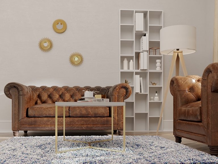 A vintage leather set paired with a modern built-in bookcase in a Transitional living space