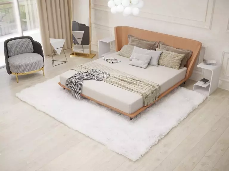 An orange accent bed in a Modern light-colored bedroom