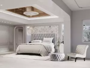 Tufted patterns and fine wall molding art in a spacious and well-lit gray bedroom