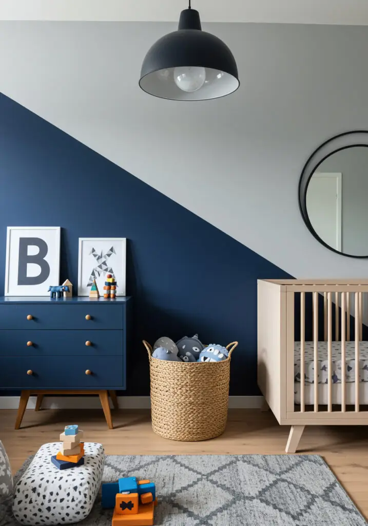 Beechwood crib beside a navy diagonal accent wall and navy dresser.