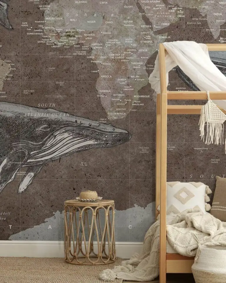 Children's bedroom with a vintage world map mural featuring a whale illustration and wooden house bed.