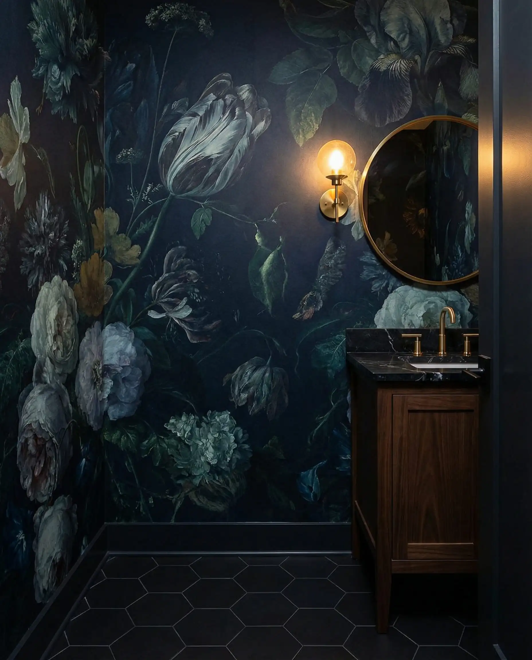 A bold powder room featuring a large-scale, moody floral botanical waterproof wallpaper with a dark background. This powder room features Dark background (navy/black), deep floral colors (reds, greens), black matte, and warm brass tones and a dramatic, bold, luxurious atmosphere.
