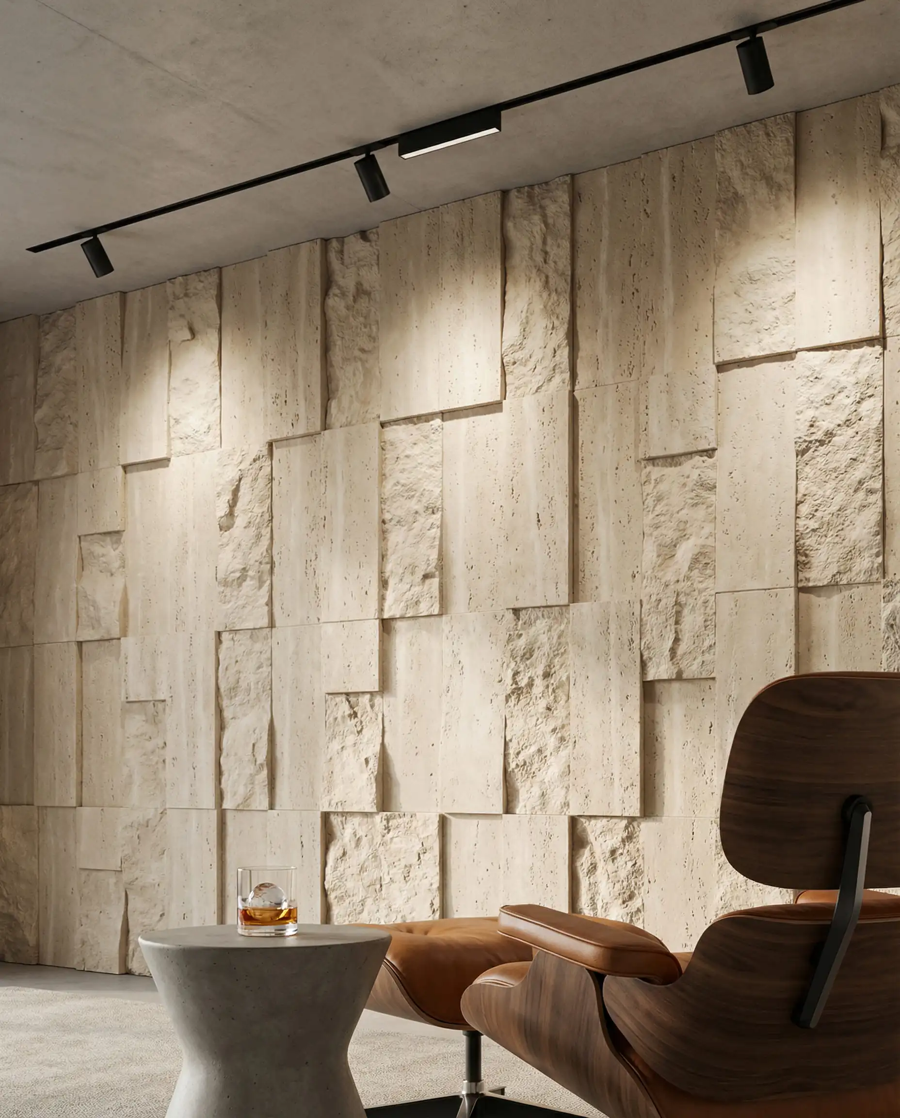 Living room feature wall with 3D wallpaper mimicking chiseled limestone blocks, highlighted by track lighting.