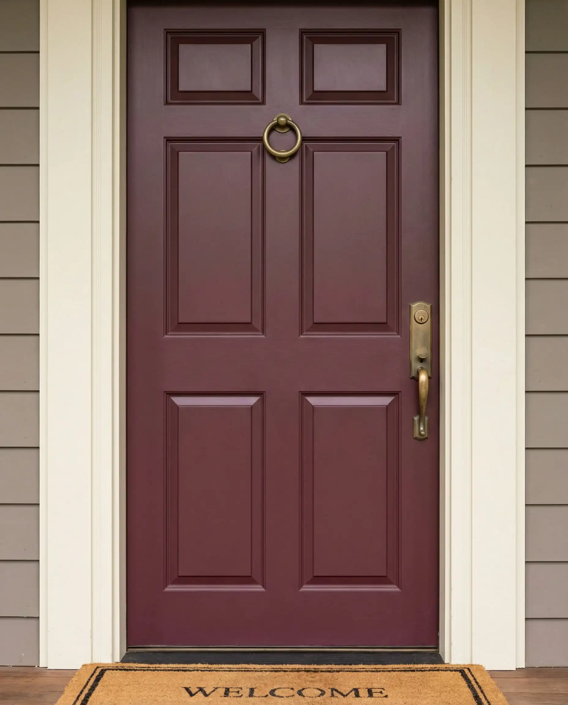 Close-up of a classic 6-panel front door painted in a deep, sophisticated Merlot red.