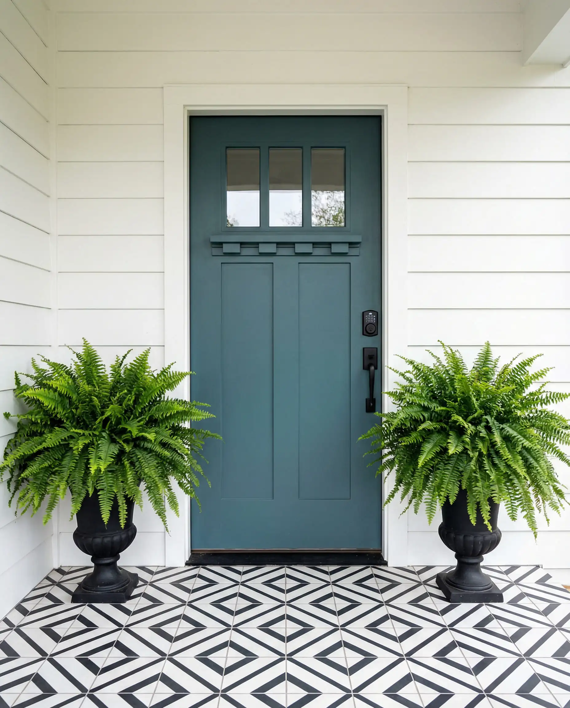 Smoky teal blue-green craftsman front door with matte black smart lock and geometric porch tiles.