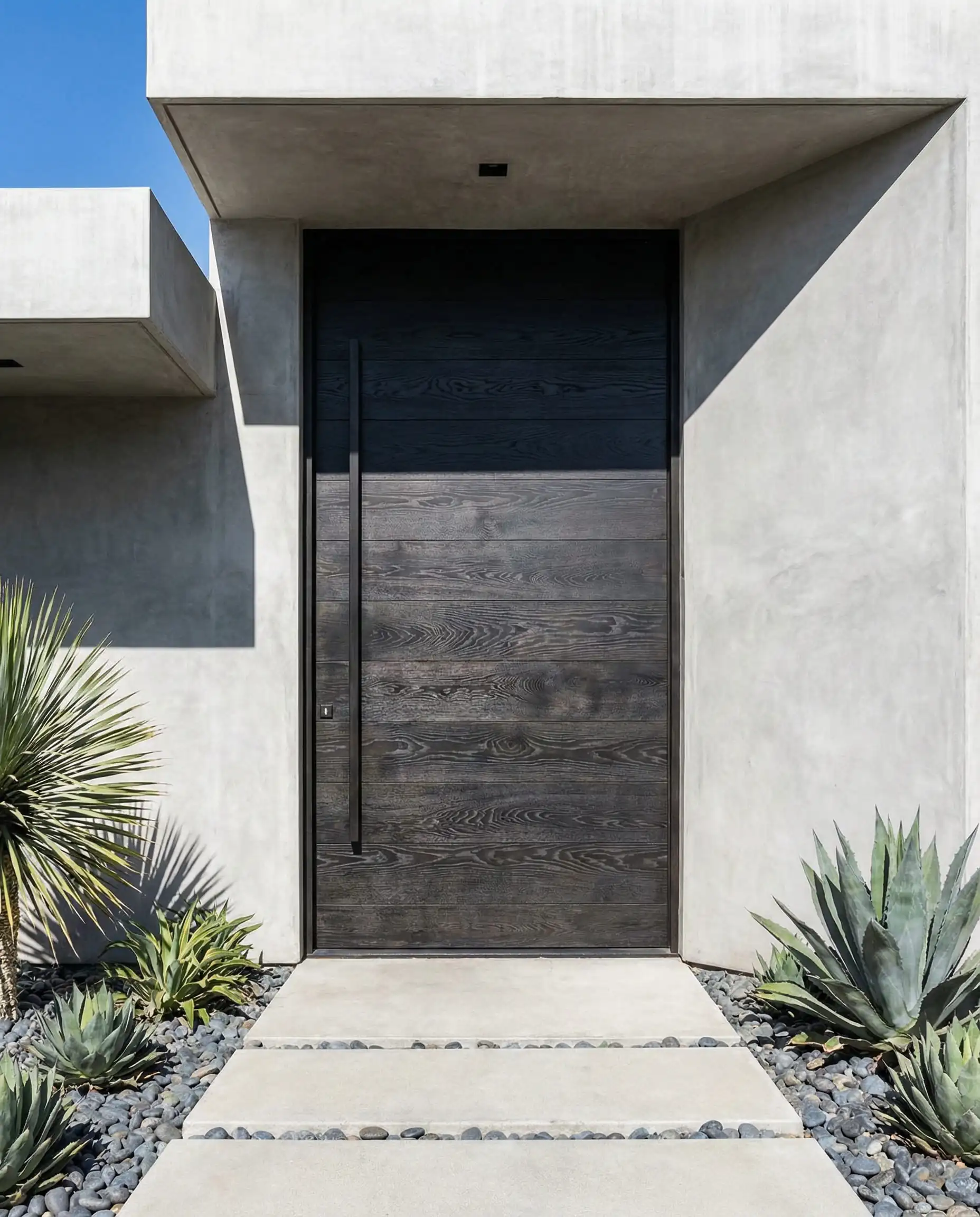 Modern charcoal black stained wood door showing visible natural wood grain texture.