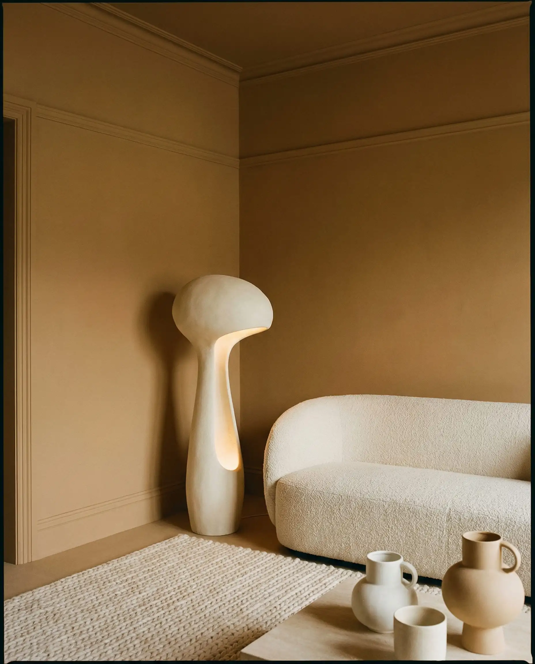 A living room completely 'Color Drenched' in a warm, toasted sesame/sand color. This living room features Warm sand, beige, bone white tones and a warm minimalism, earthy, cocooning atmosphere.