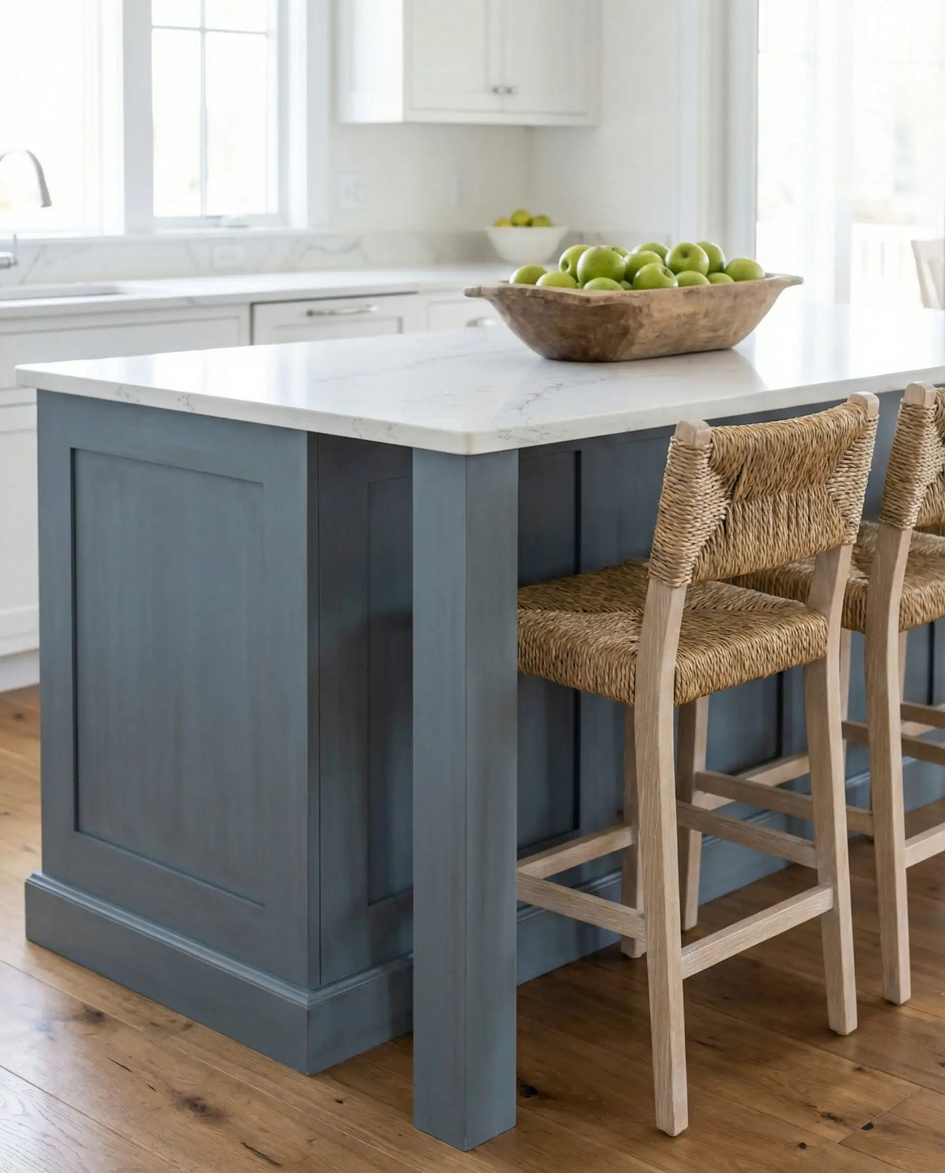 Coastal kitchen island painted in slate blue Behr Adirondack Blue with white quartz countertops.