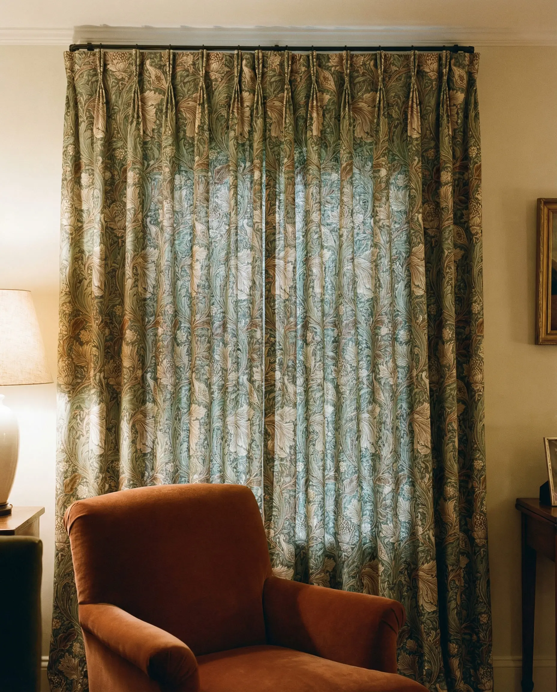 Botanical print curtains in sage and brown with pinch pleats.