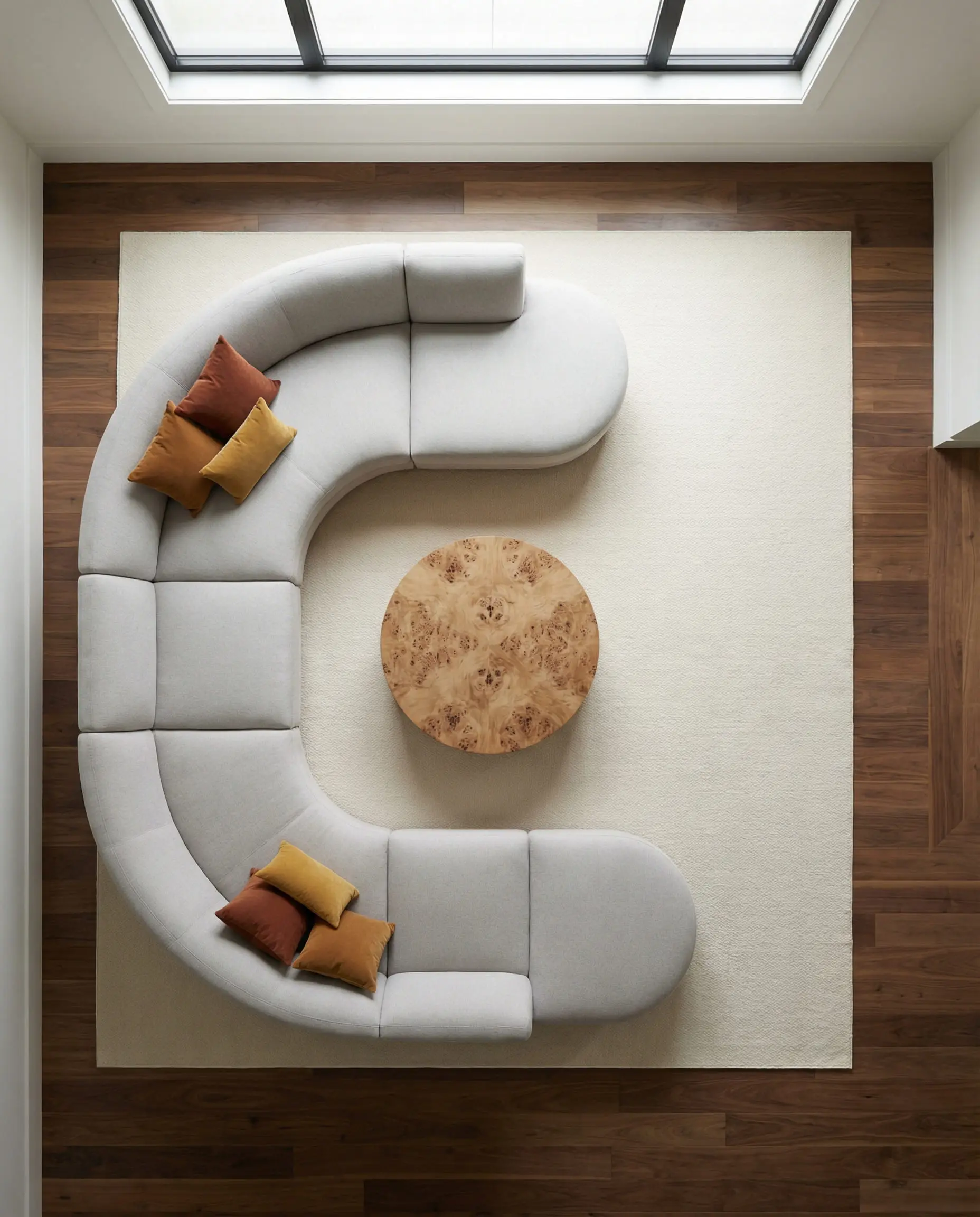 Top-down view of kidney-bean shaped sectional sofa in a modern family room.