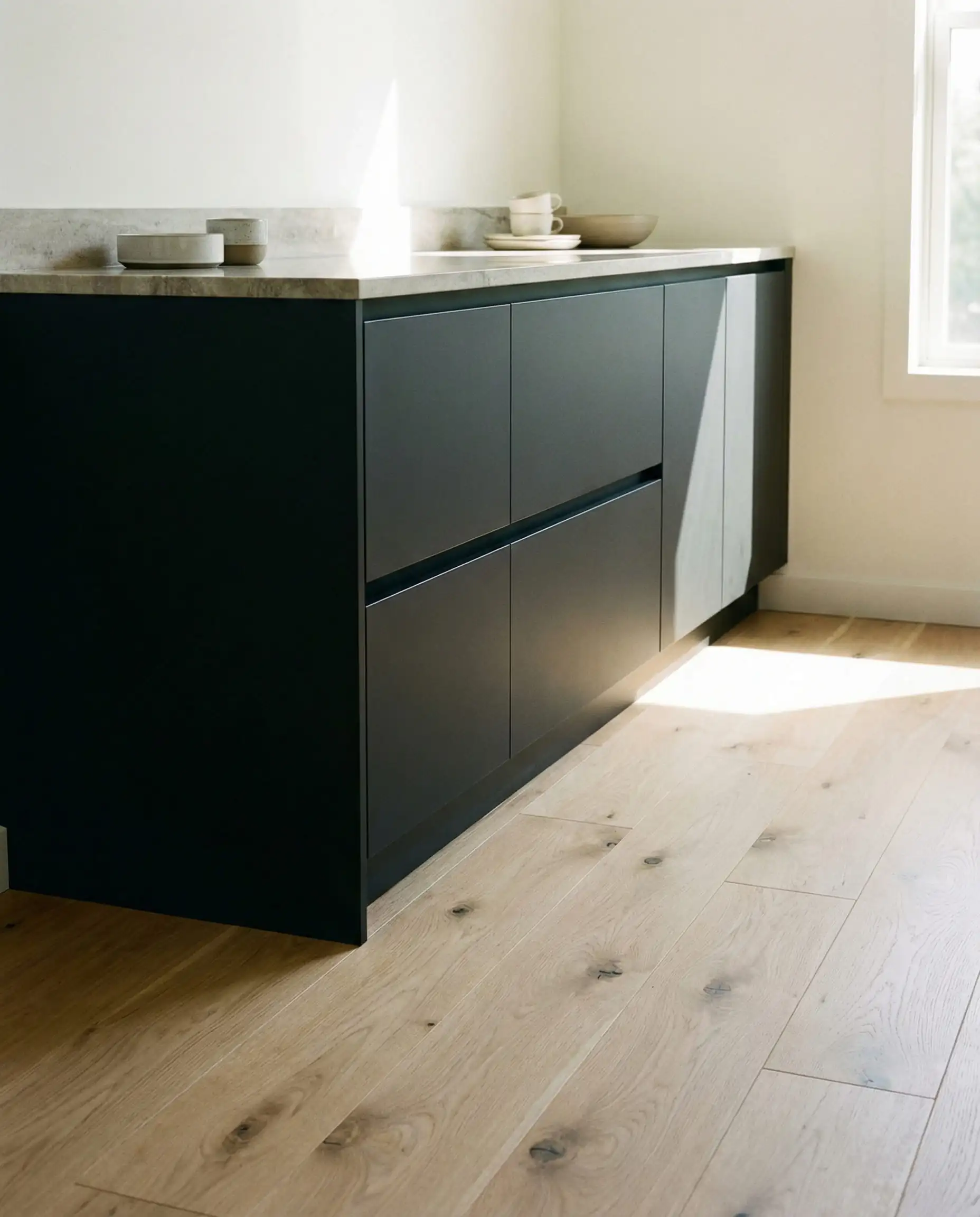 Sherwin-Williams Iron Ore cabinets paired with white oak flooring.