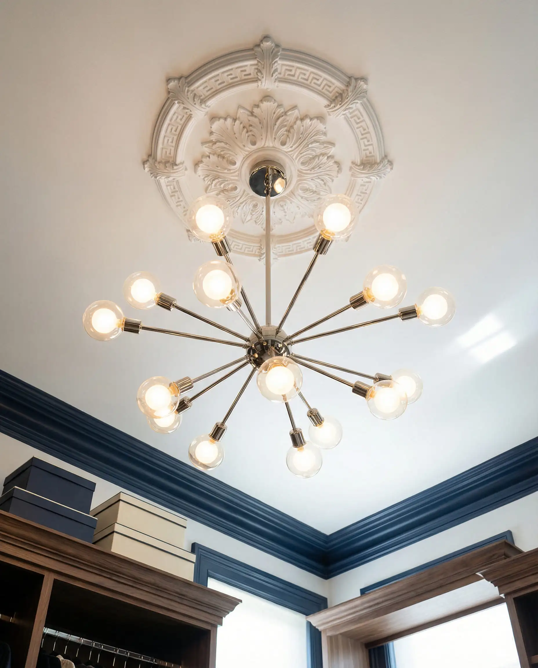 Sputnik-style brass chandelier hanging from a coffered ceiling in a luxury walk-in closet.
