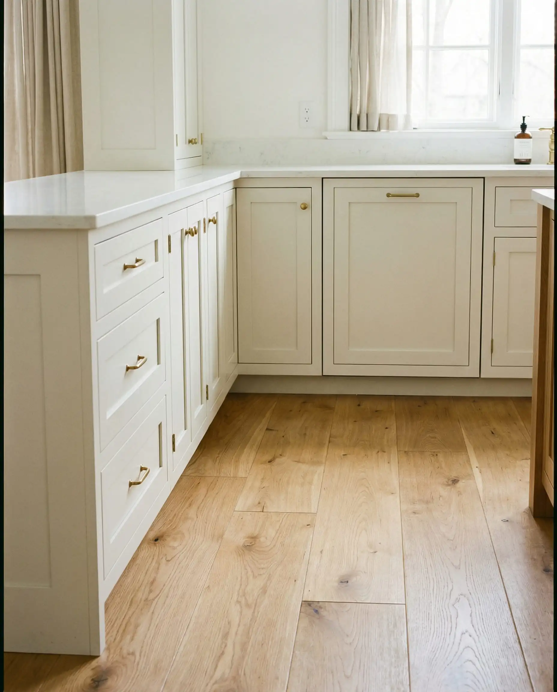 Sherwin-Williams Pure White cabinets paired with white oak flooring.