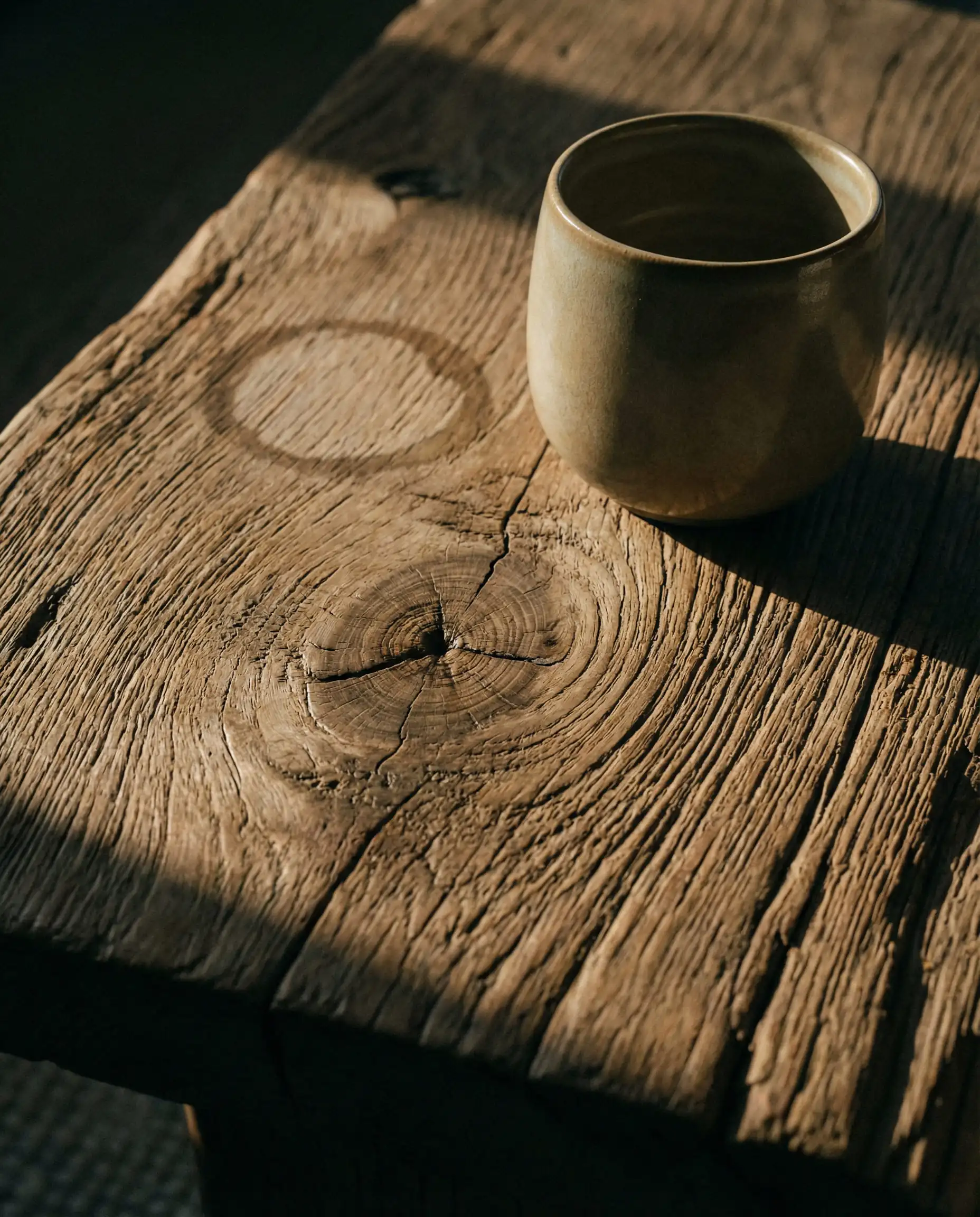Close up of reclaimed wood coffee table showing knots and imperfections.