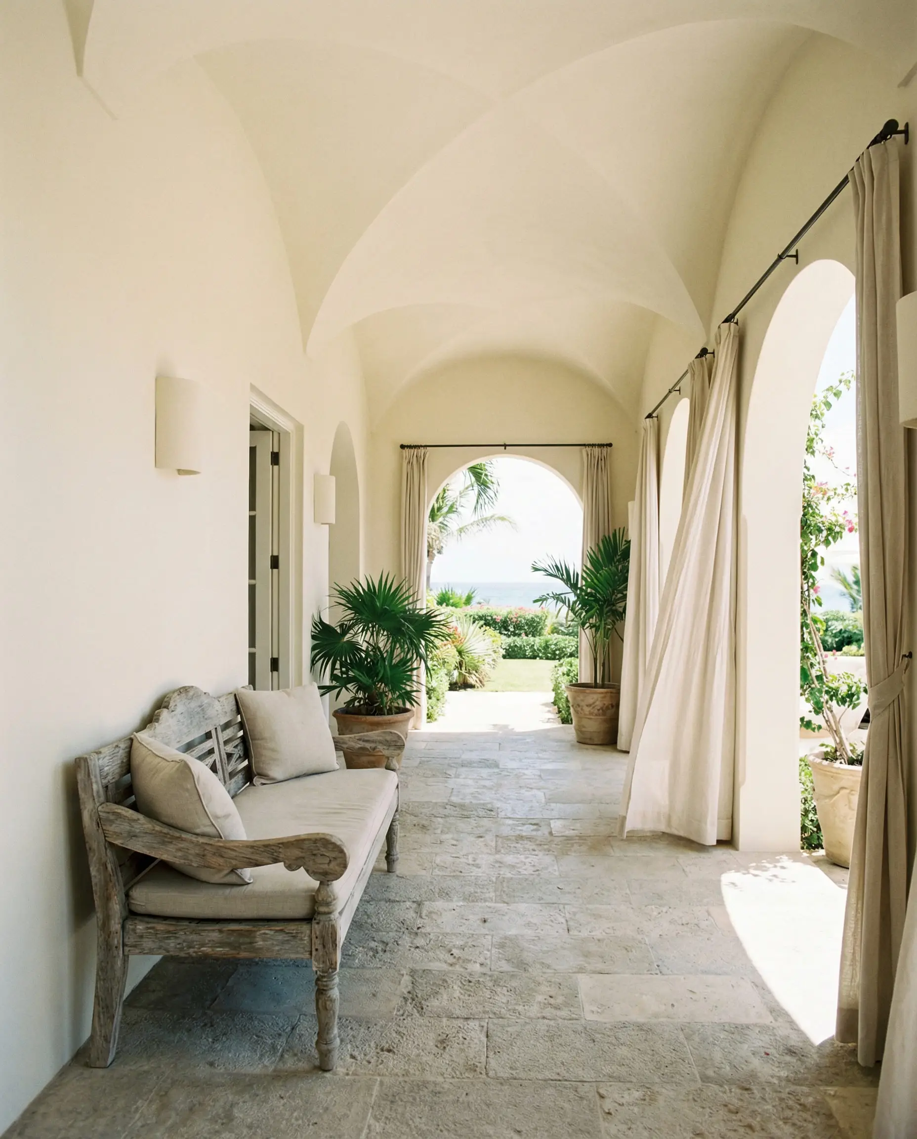 Covered loggia painted in Sherwin-Williams Greek Villa reflecting bounce light.