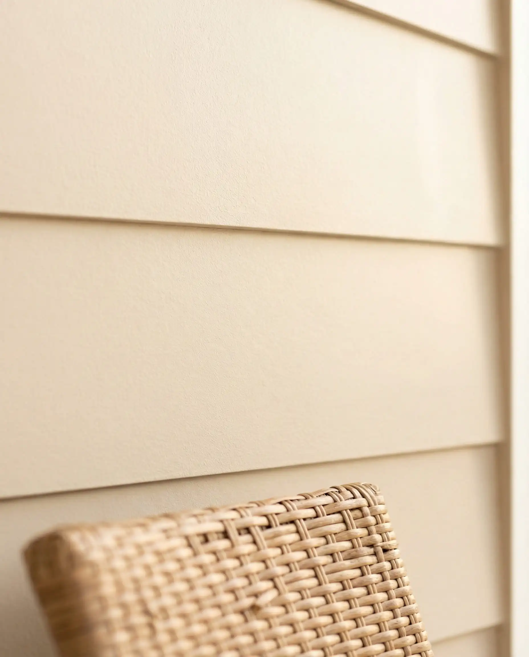 Macro texture shot of smooth fiber cement siding painted in Sherwin-Williams Natural Linen.