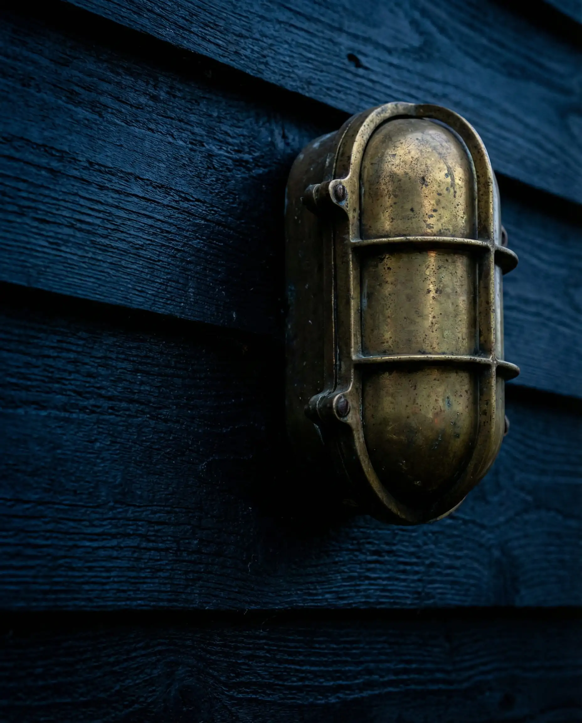 Close-up of painted wood grain in Sherwin-Williams Naval showing deep blue pigment.