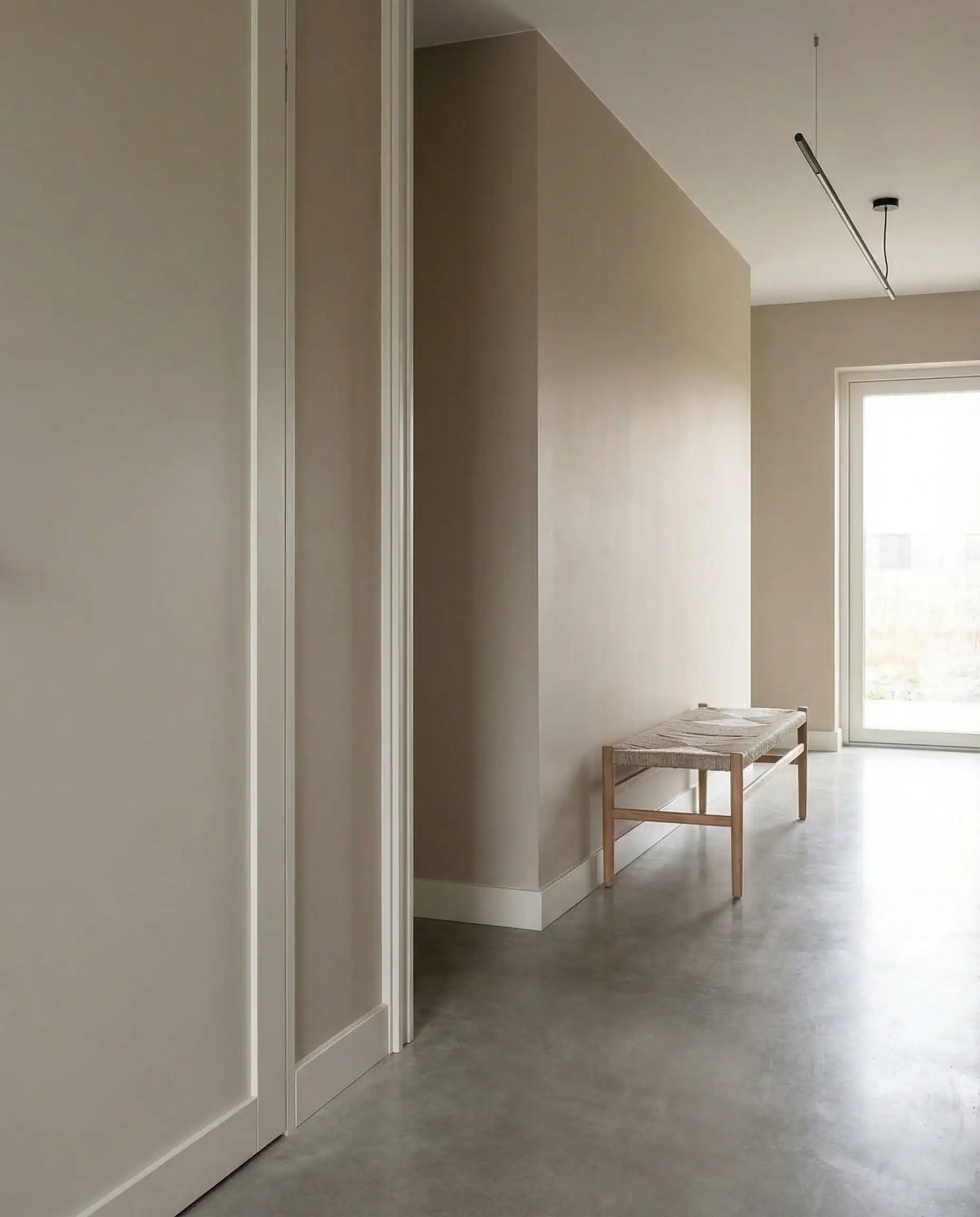 Modern hallway with earthy clay walls and sleek baseboards painted in Sherwin-Williams Pure White.