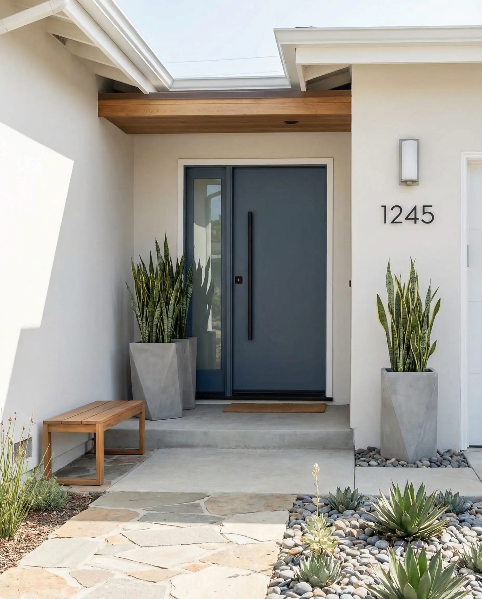 Modern front entry with Sherwin-Williams Snowbound siding and concrete planters.