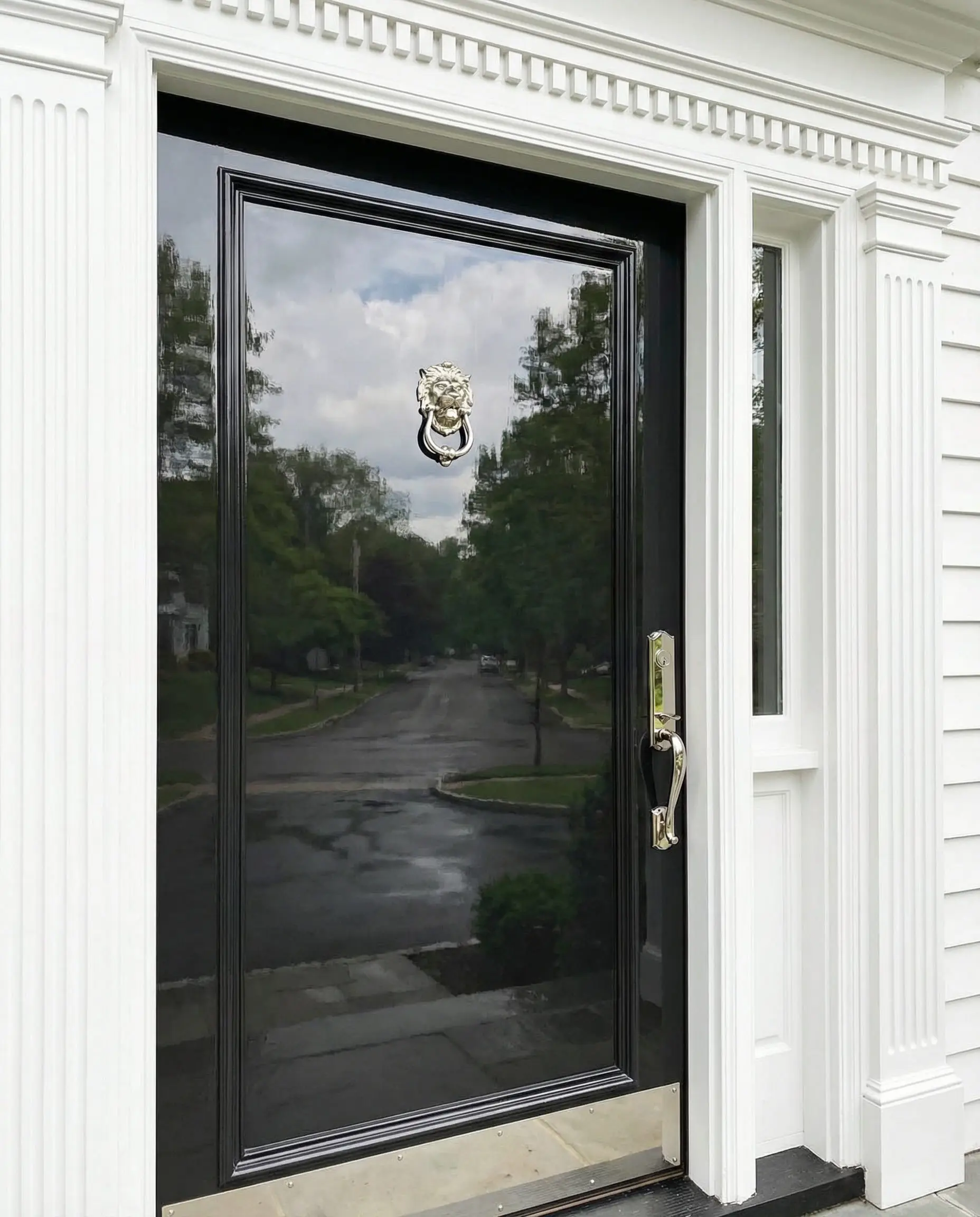 High-gloss front door painted in Sherwin-Williams Tricorn Black reflecting the street.