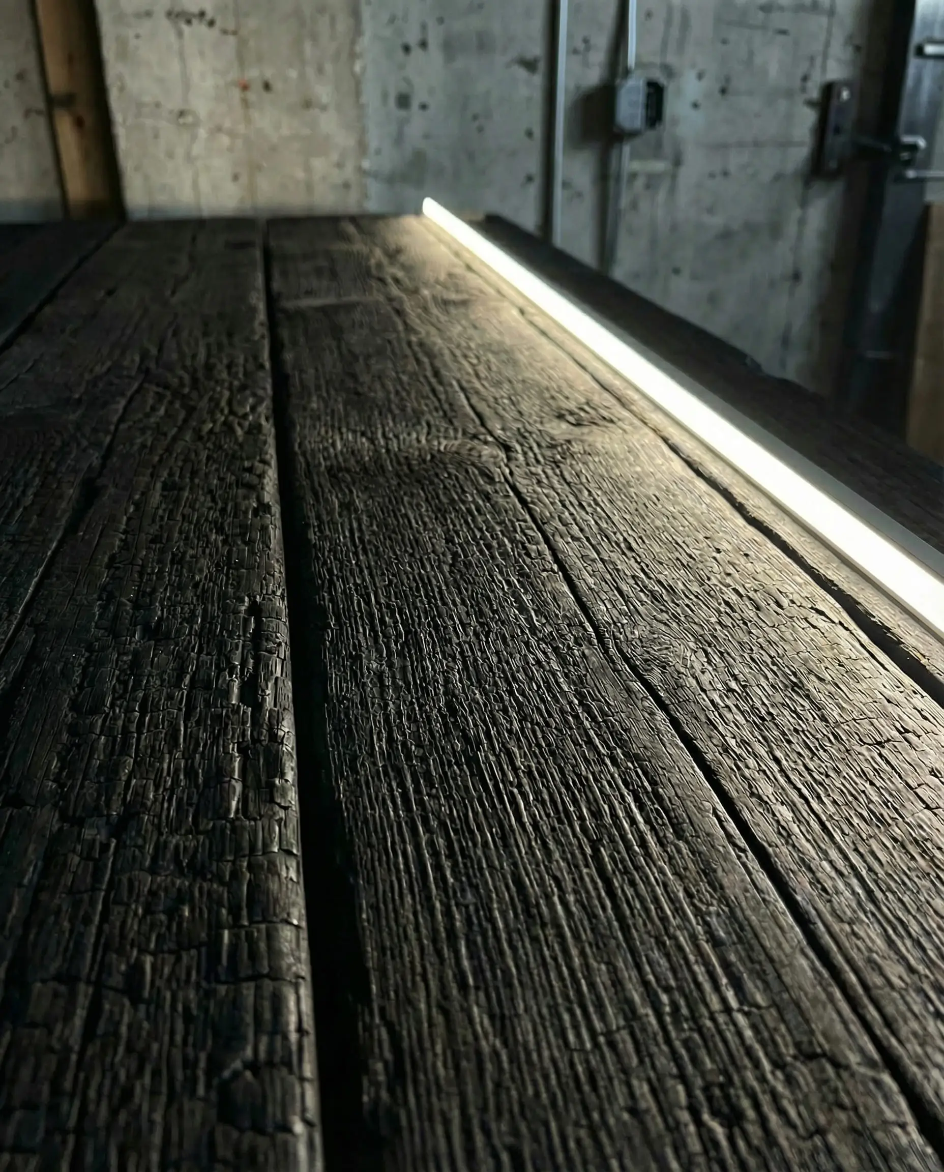 Black stained wood siding in Sherwin-Williams Tricorn Black showing Shou Sugi Ban look.