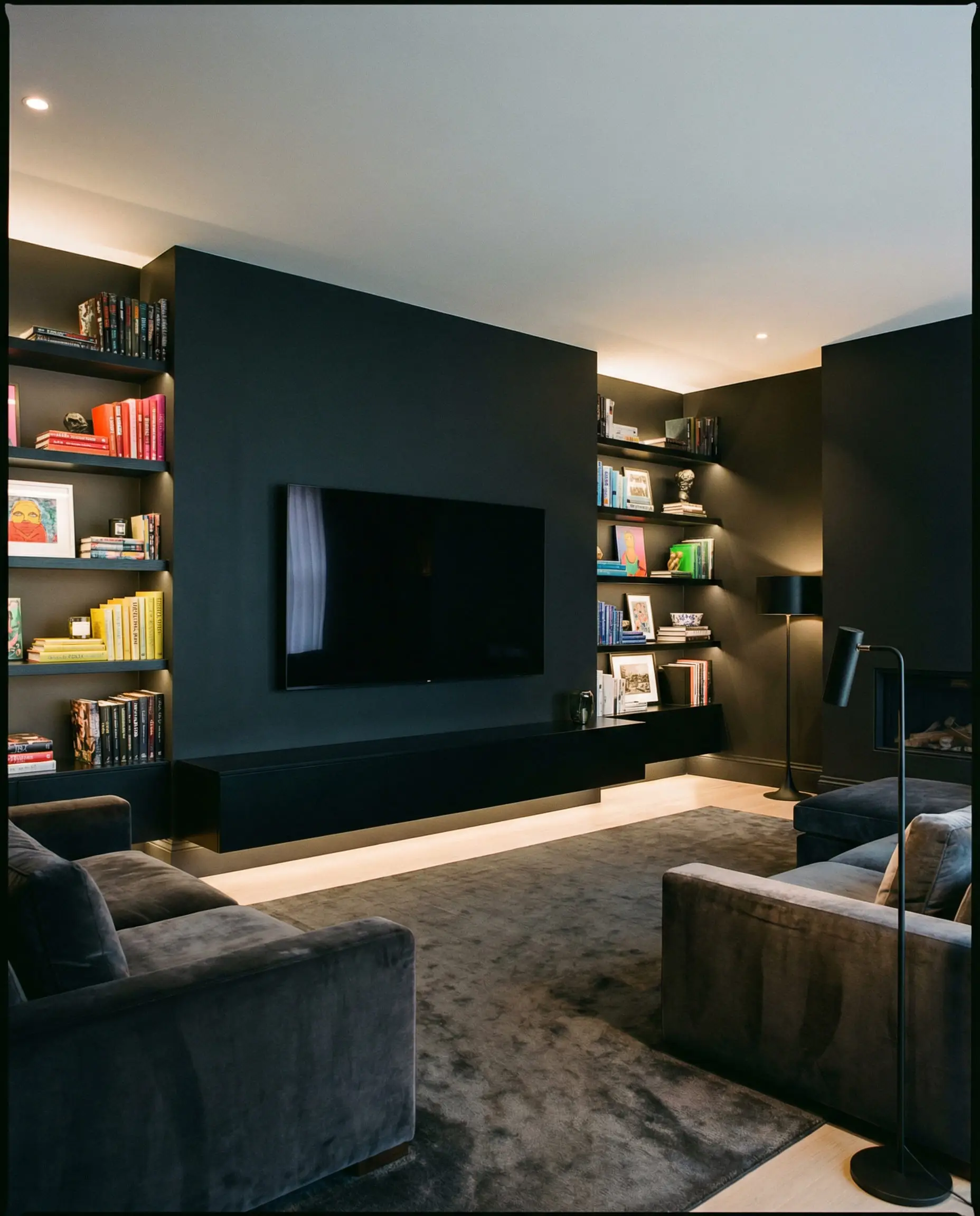 Flat screen TV mounted on a charcoal black wall to blend in.