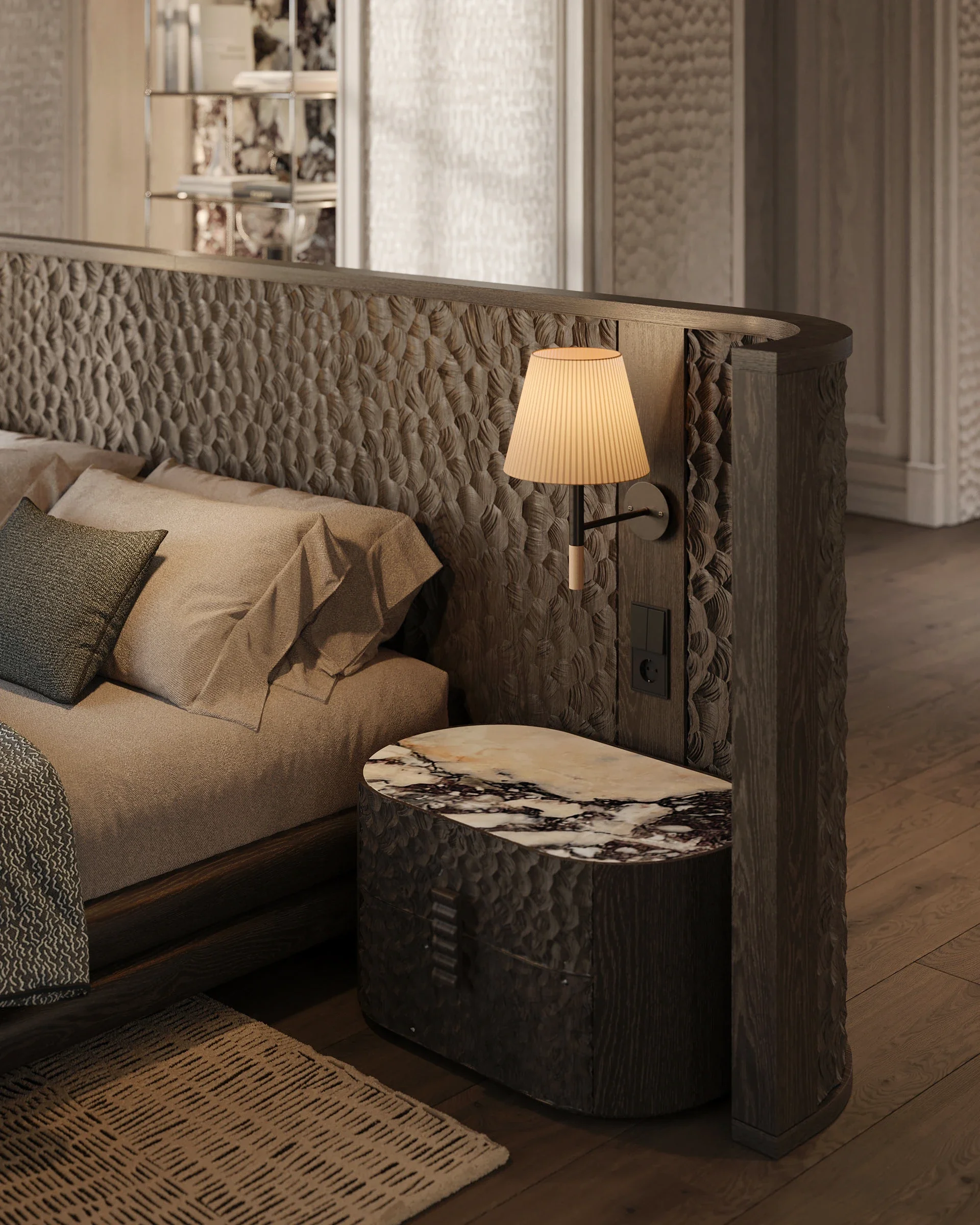 Close-up of a luxury bedroom featuring a custom curved headboard with heavily textured dark wood, a built-in reading lamp, and a unique nightstand with a heavily veined black and white marble top.