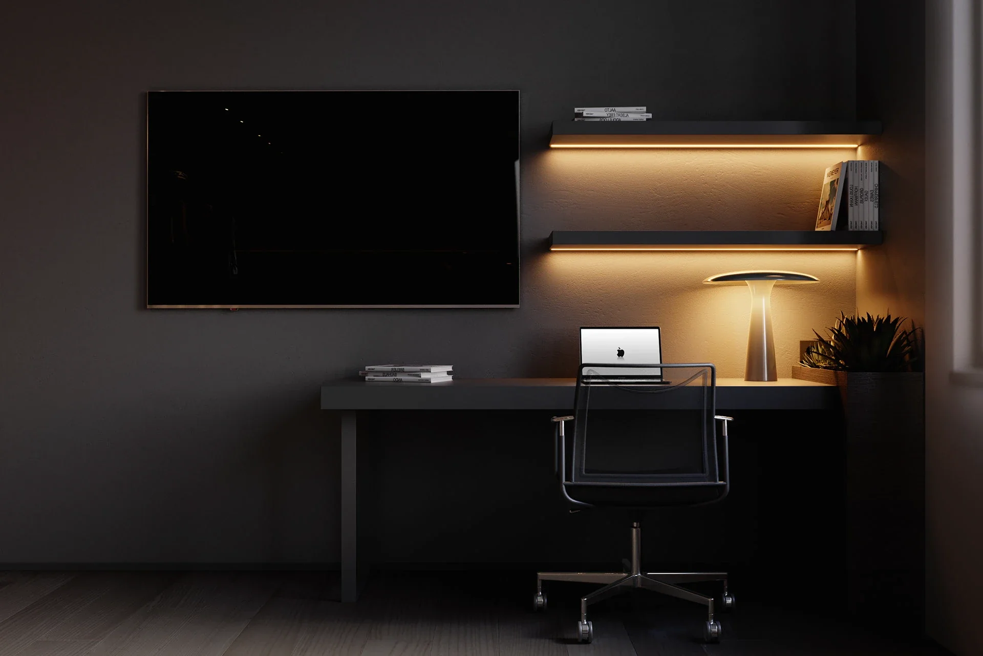 A moody, minimalist home office space featuring dark grey walls, a sleek floating desk with a laptop, a large wall-mounted TV, and two floating shelves illuminated by warm under-mount LED lighting.