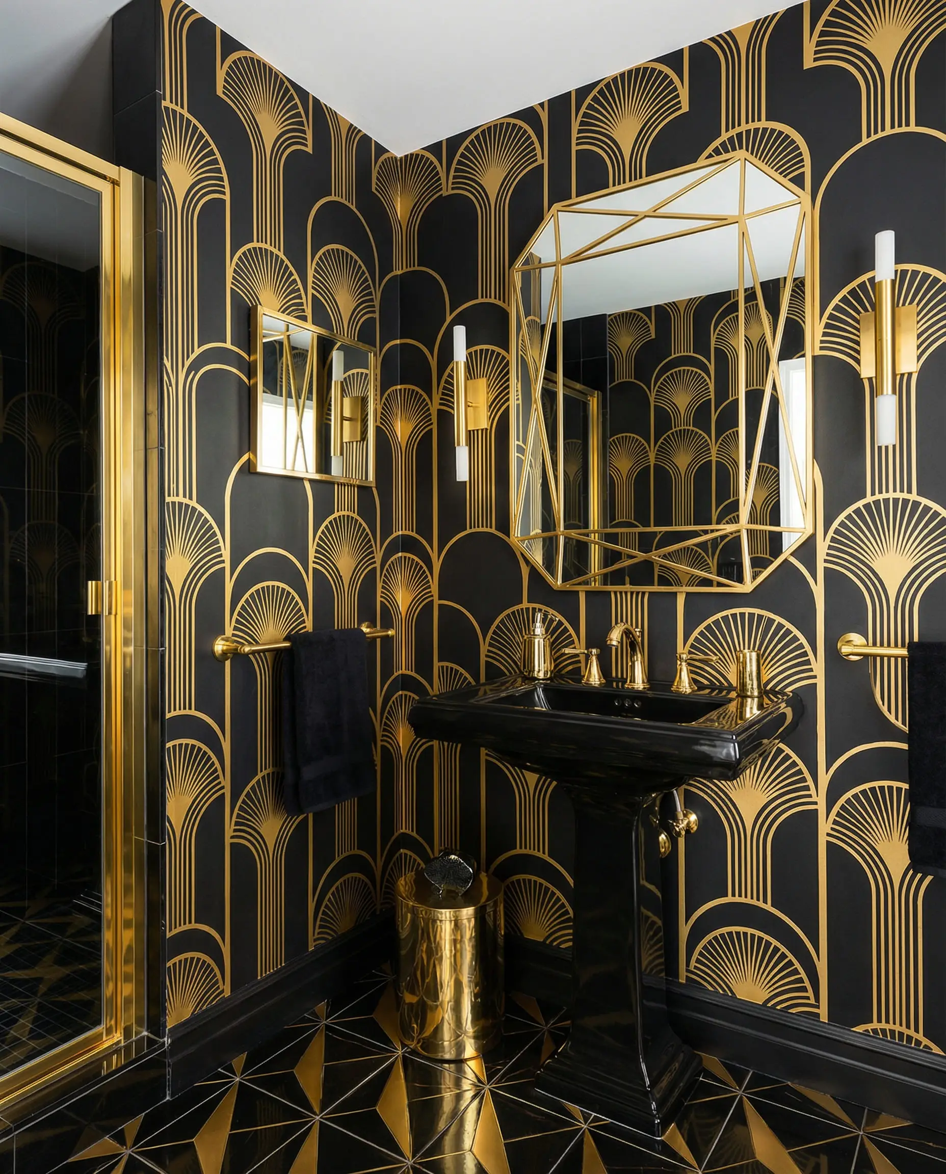 Bold black and gold geometric Art Deco wallpaper in a high-contrast guest bathroom.