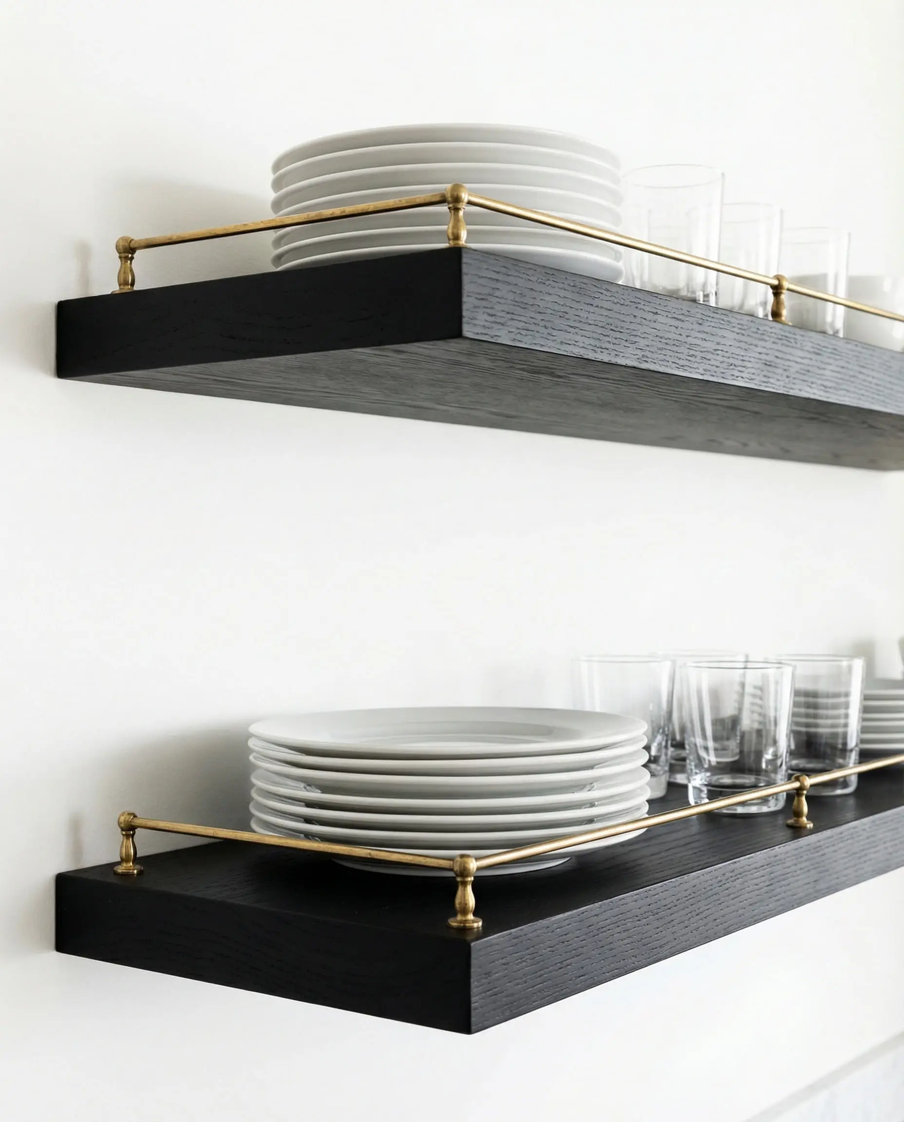 Black floating shelves featuring a decorative vintage-style brass gallery rail.