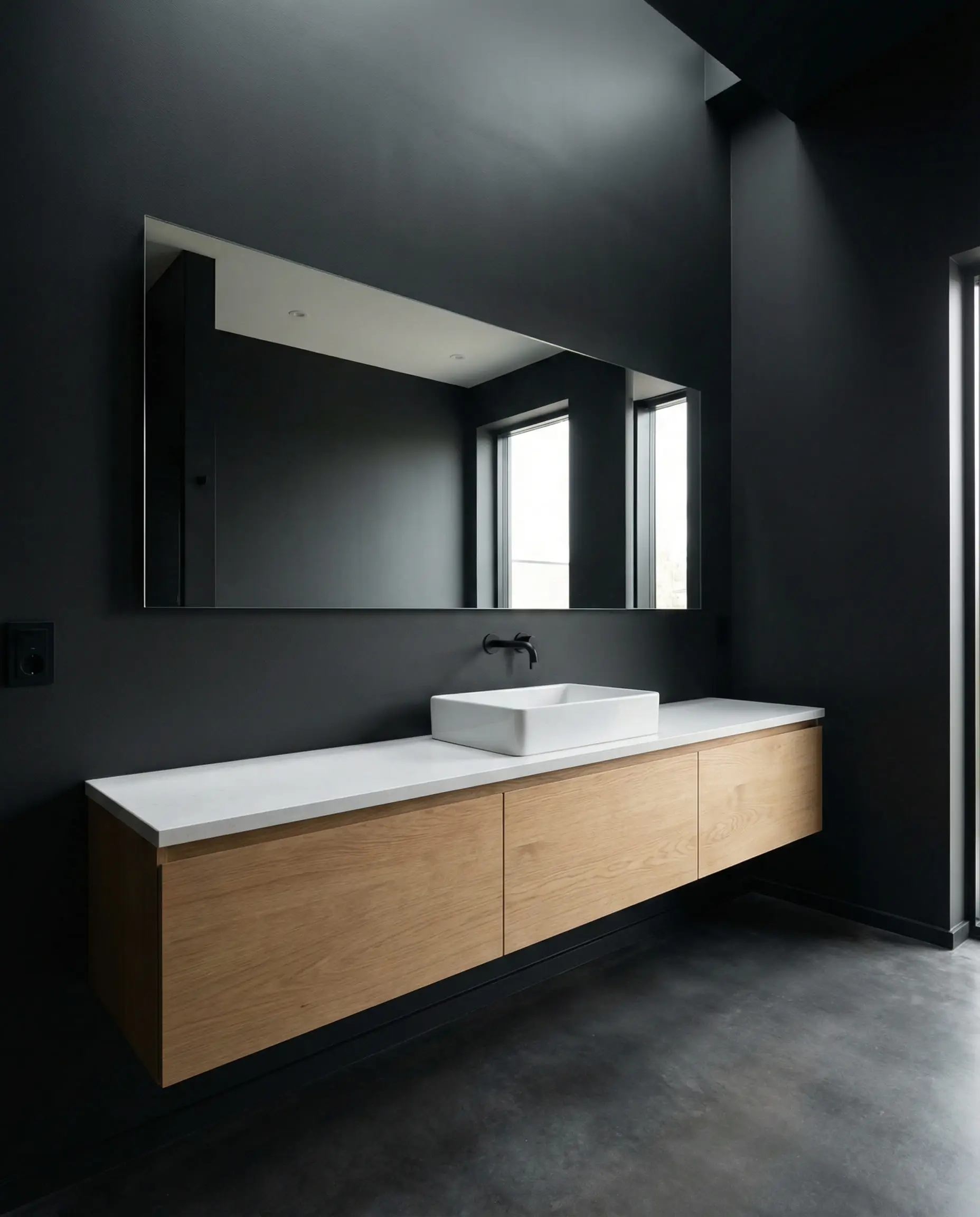 Modern master bath with a matte charcoal accent wall contrasting with a white oak vanity.