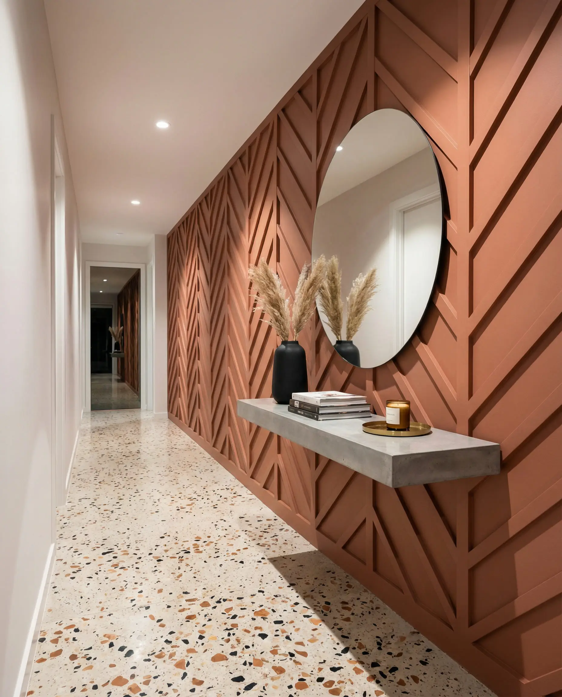 Modern hallway with bold chevron board and batten accent wall painted in terracotta with concrete console table.