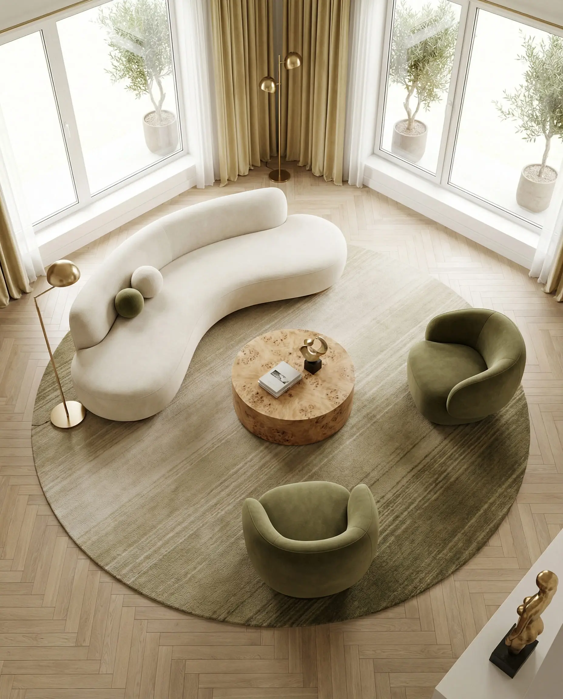 Overhead view of a living room layout featuring a kidney-bean shaped sofa and round rug to facilitate conversation.
