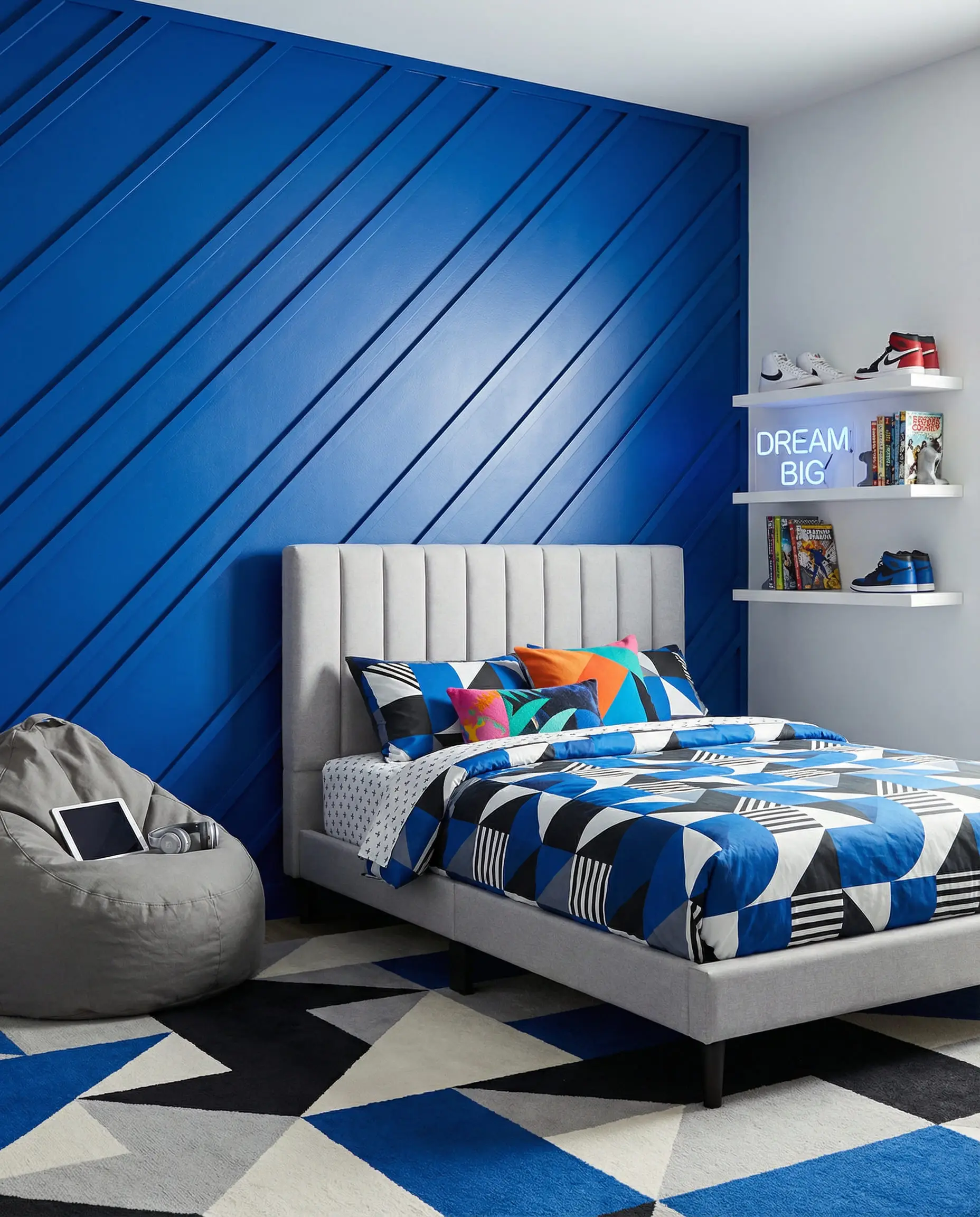 Electric blue teen bedroom accent wall with sharp diagonal board and batten slats and modern platform bed.