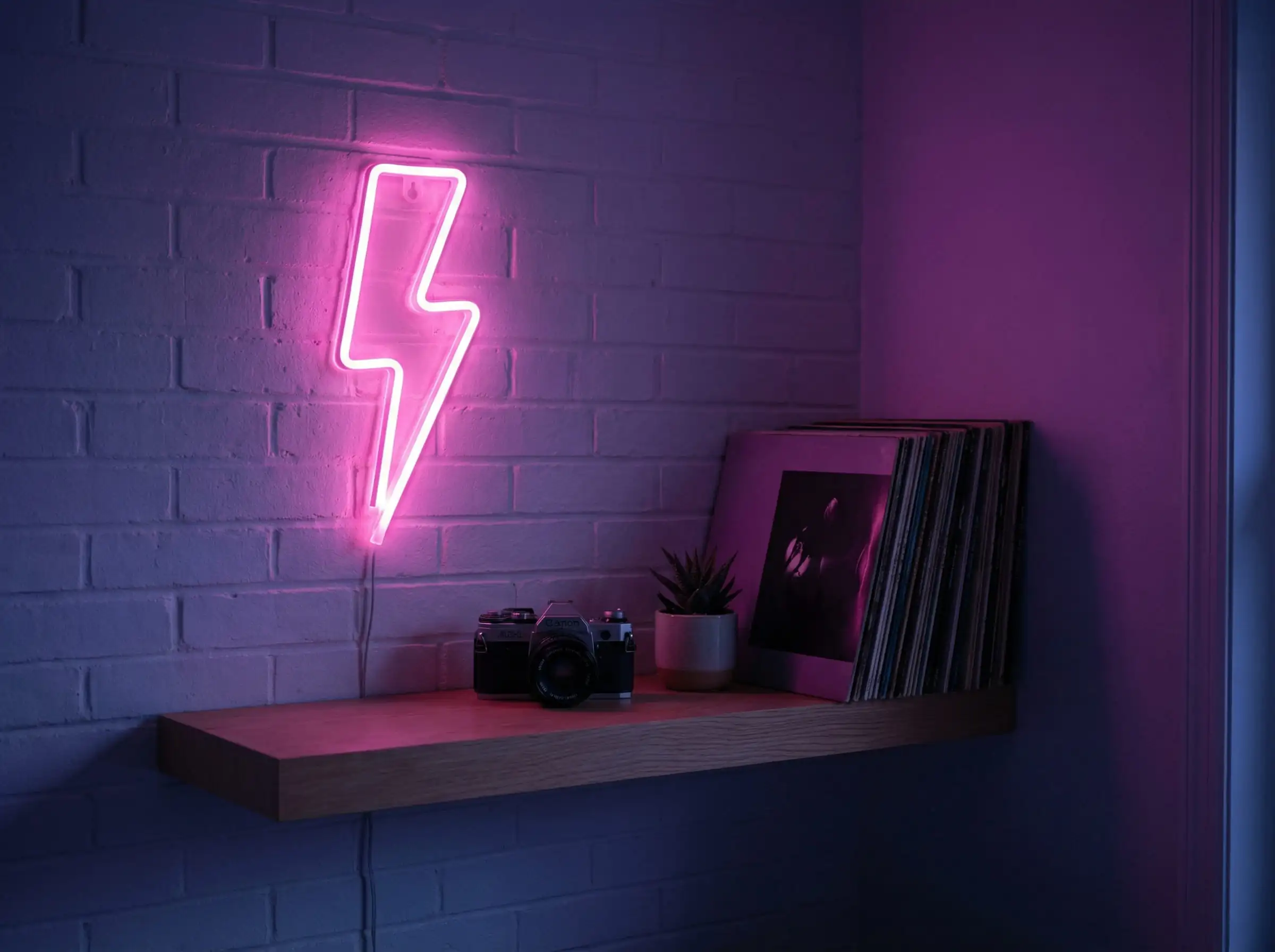 DIY neon sign made from pink LED rope light shaped like a lightning bolt on a bedroom wall.