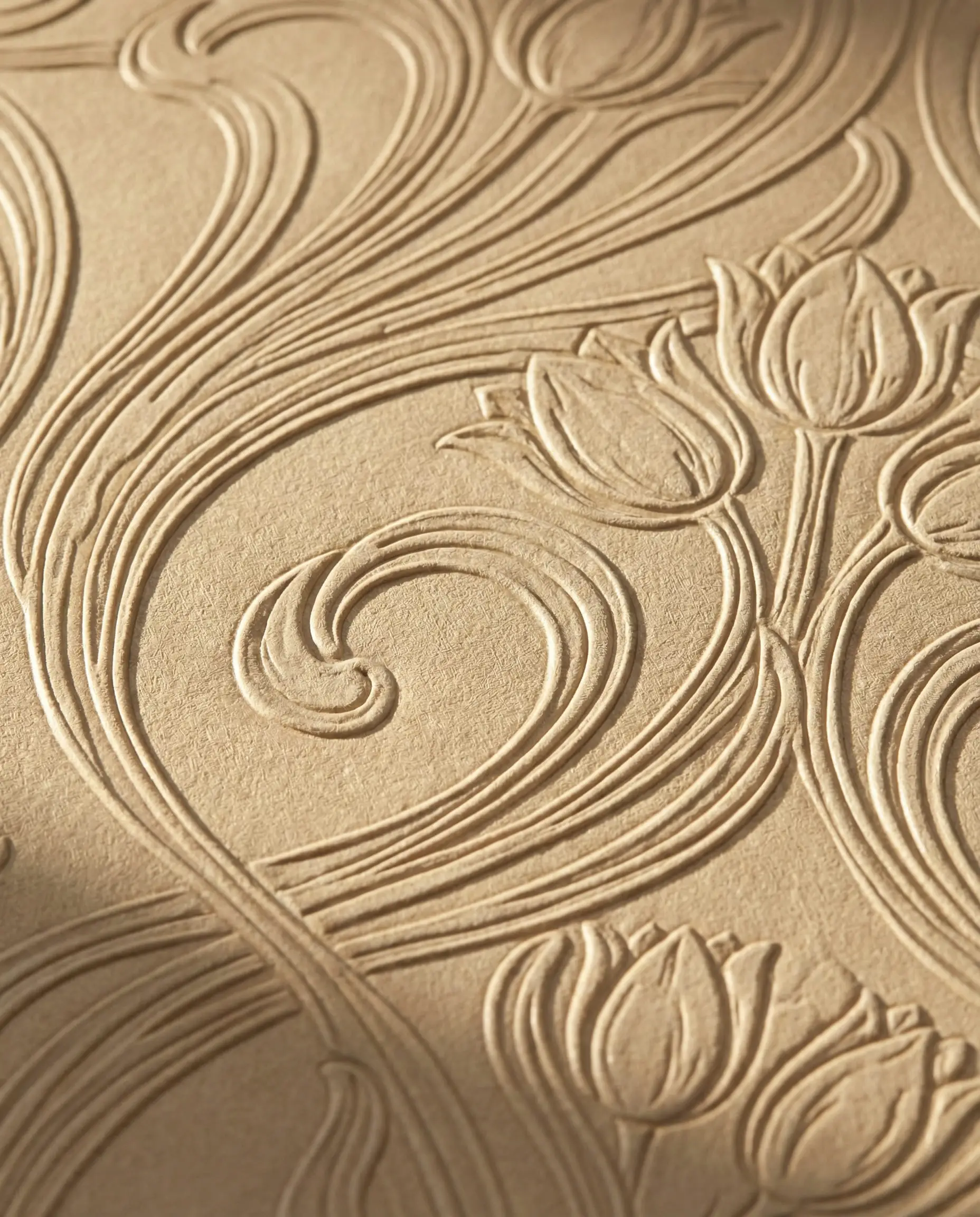 Close-up texture of beige wallpaper with raised embossed Art Nouveau swirling patterns.