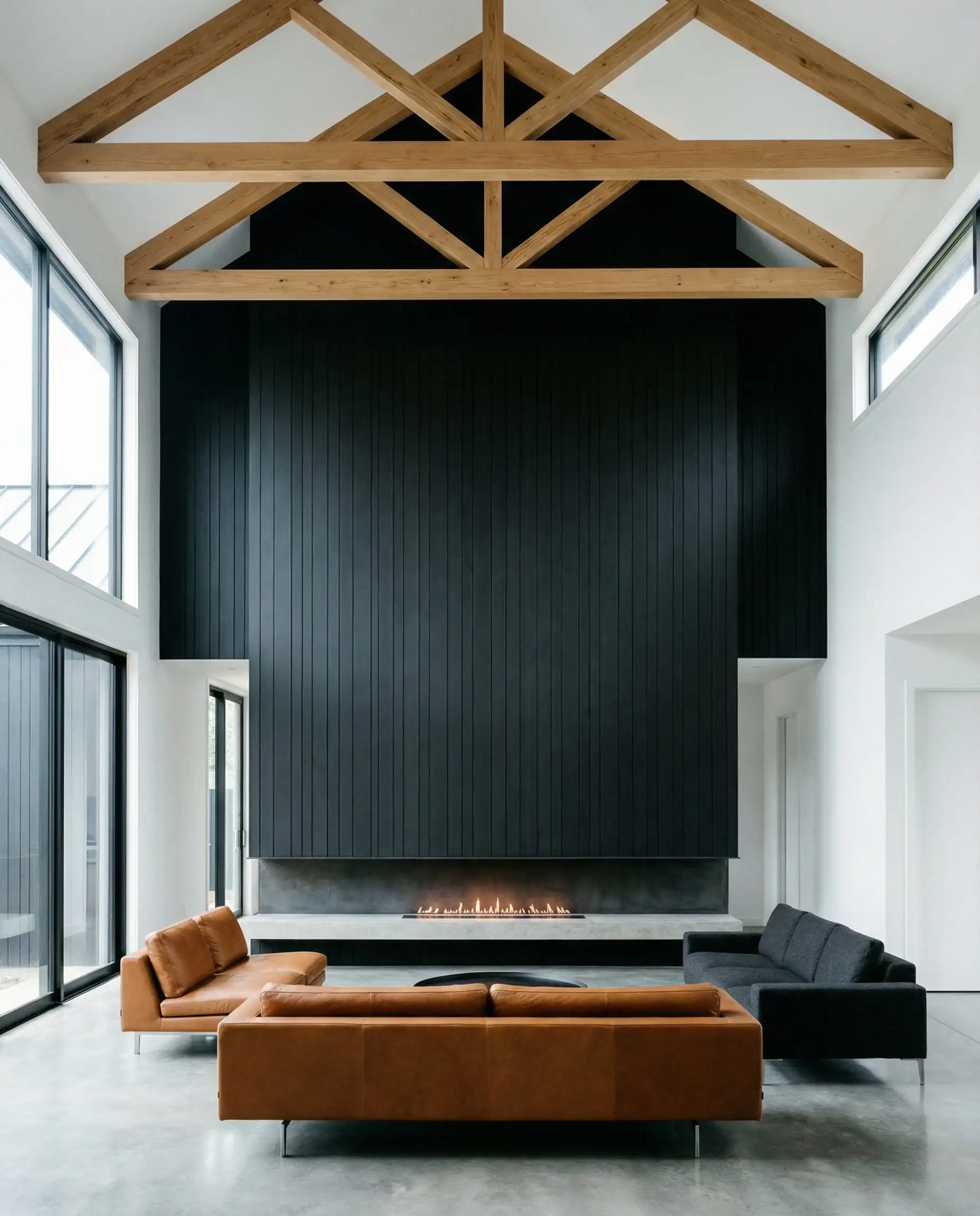 Double-height living room featuring a massive vertical black shiplap fireplace wall with a linear gas insert.