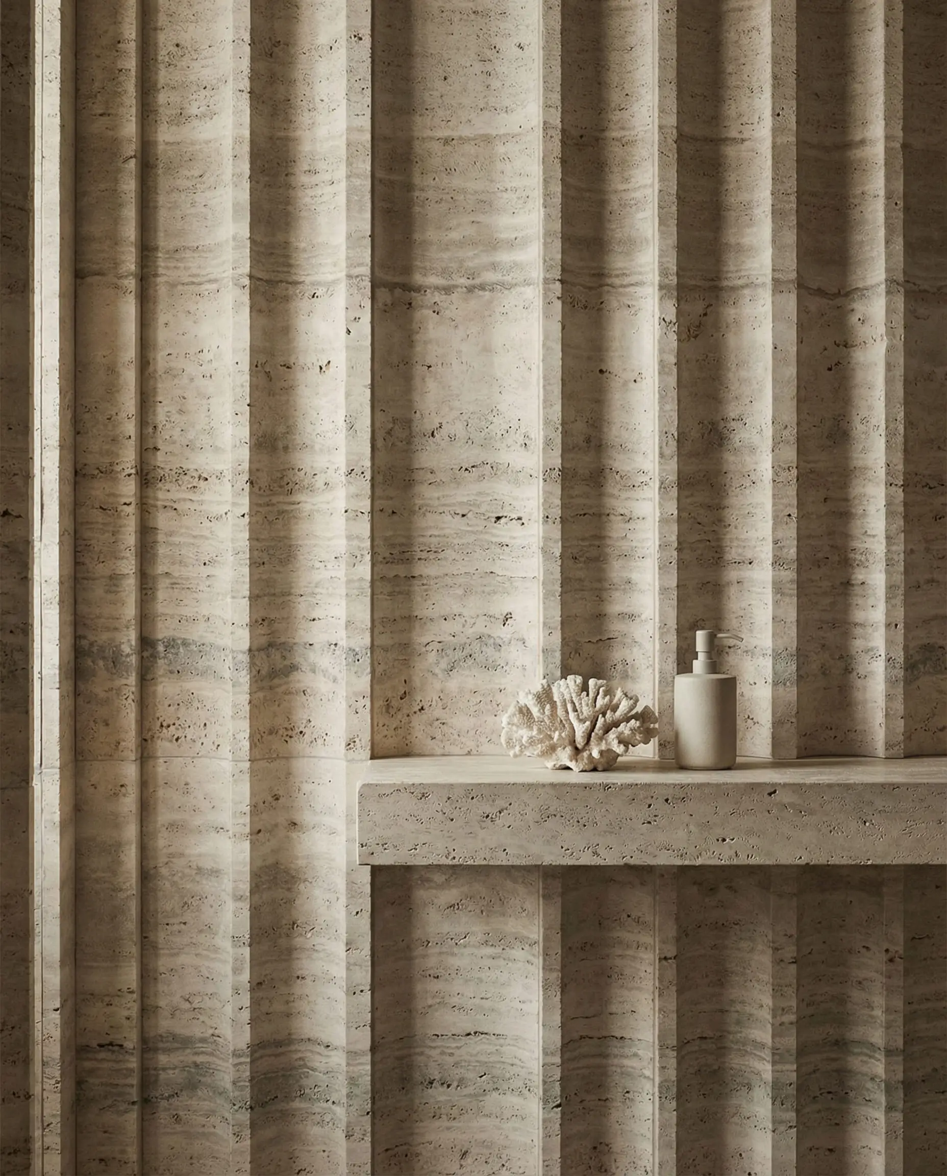 Minimalist bathroom wall clad in unfilled Silver Travertine stone with a custom fluted ribbed texture.