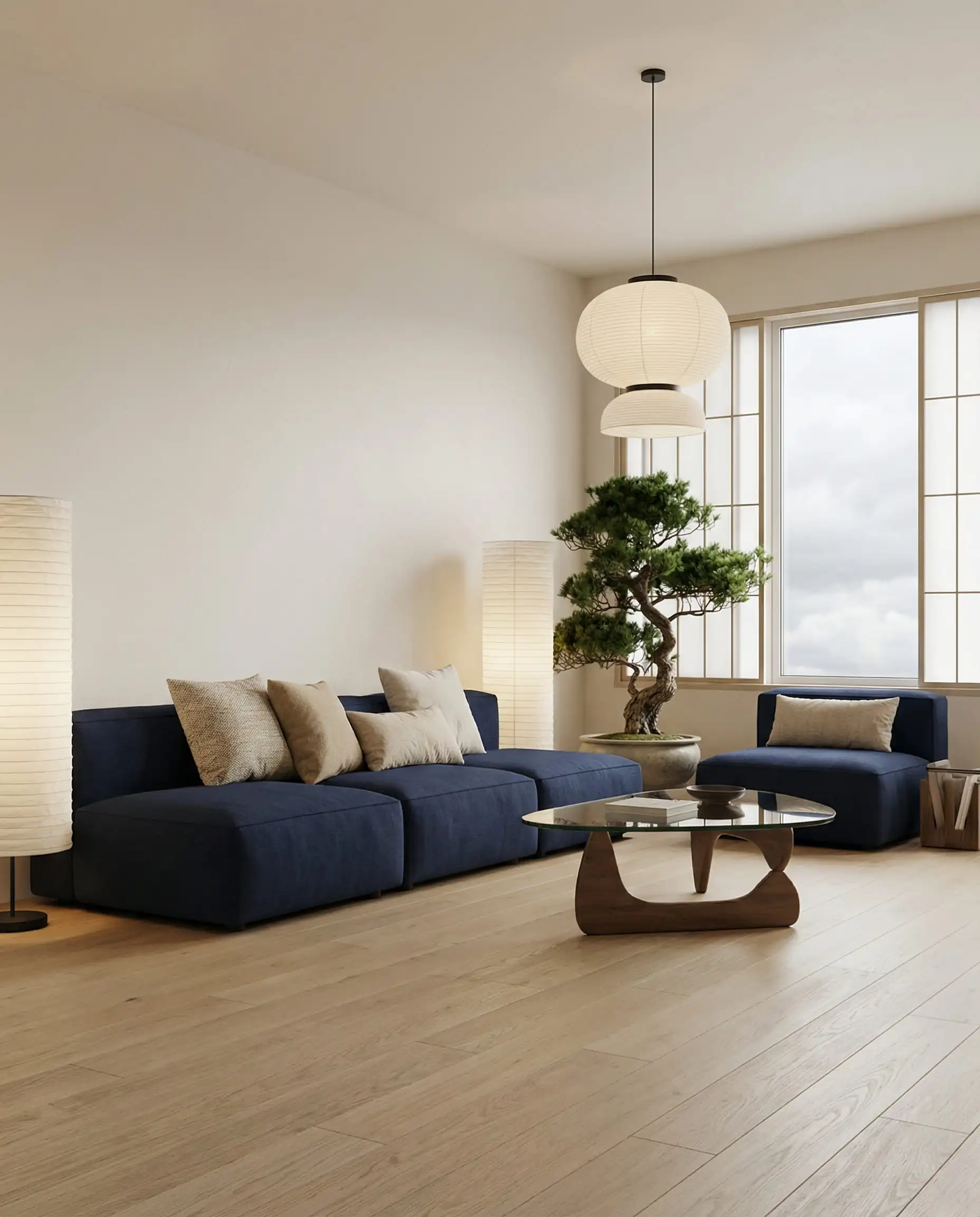 Minimalist Japandi living room featuring a low profile navy sofa with neutral oatmeal and sand linen pillows.