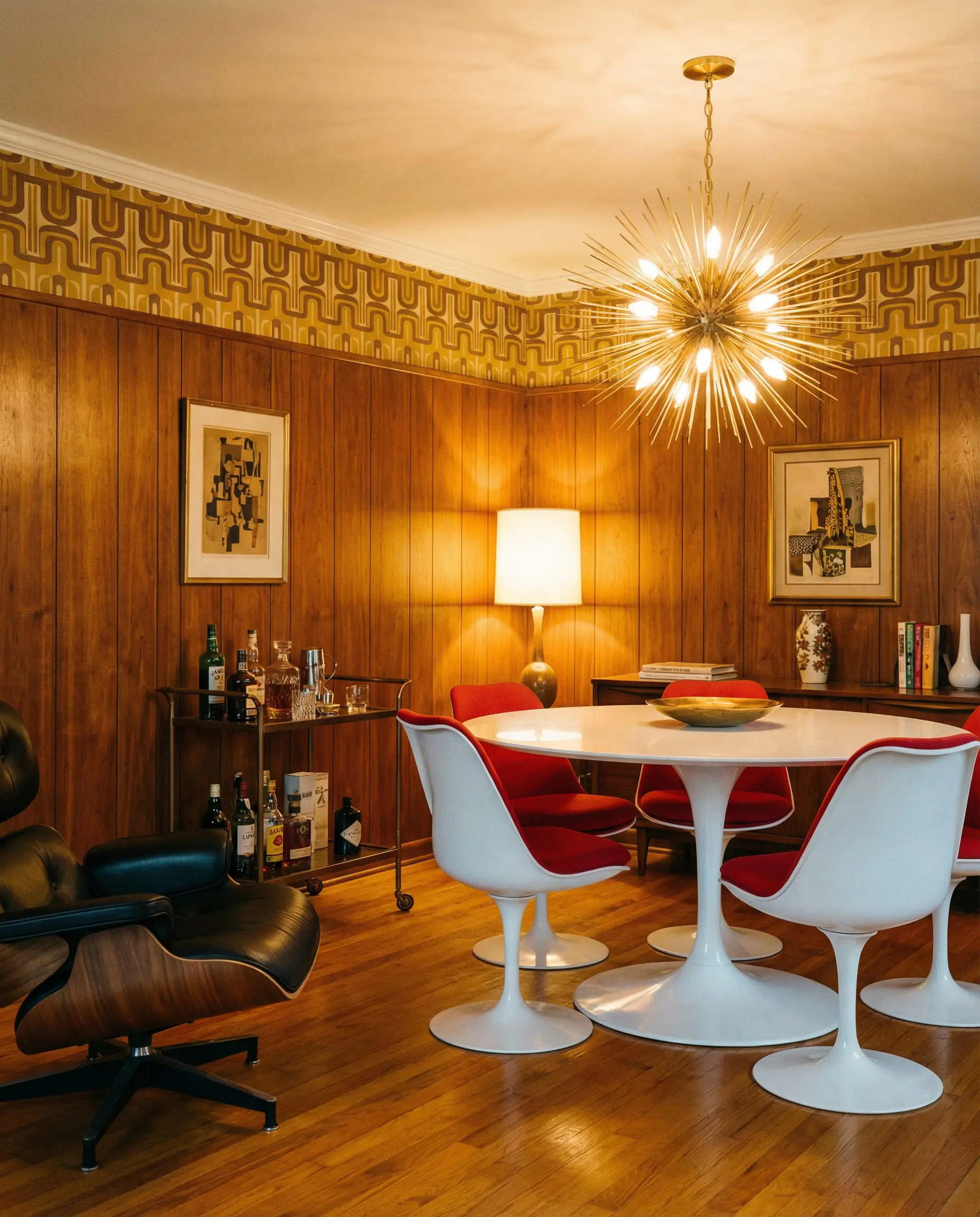 1960s inspired dining room with walnut wainscoting and mustard geometric wallpaper.