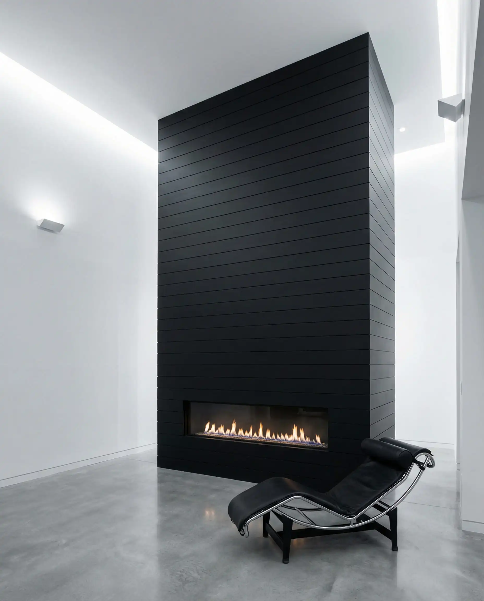 Floor-to-ceiling vertical black shiplap bump-out with a frameless linear gas fireplace and no mantel.