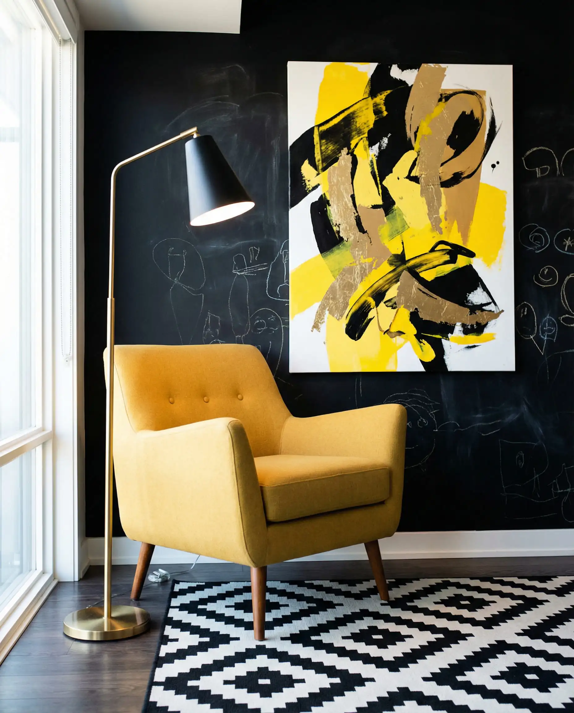 Retro-modern living corner with a mustard yellow armchair against a charcoal black wall.