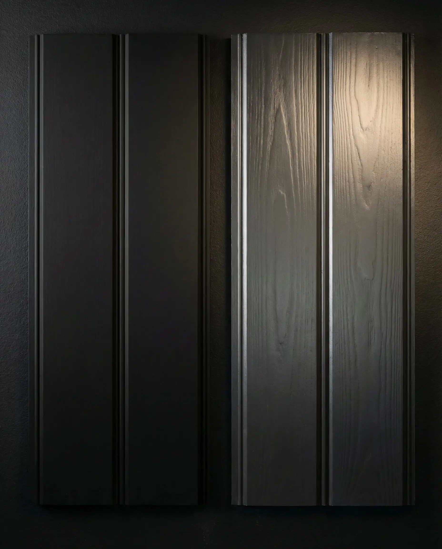 Close-up of satin finish black paint on wood shiplap showing a soft light sheen on the edges.