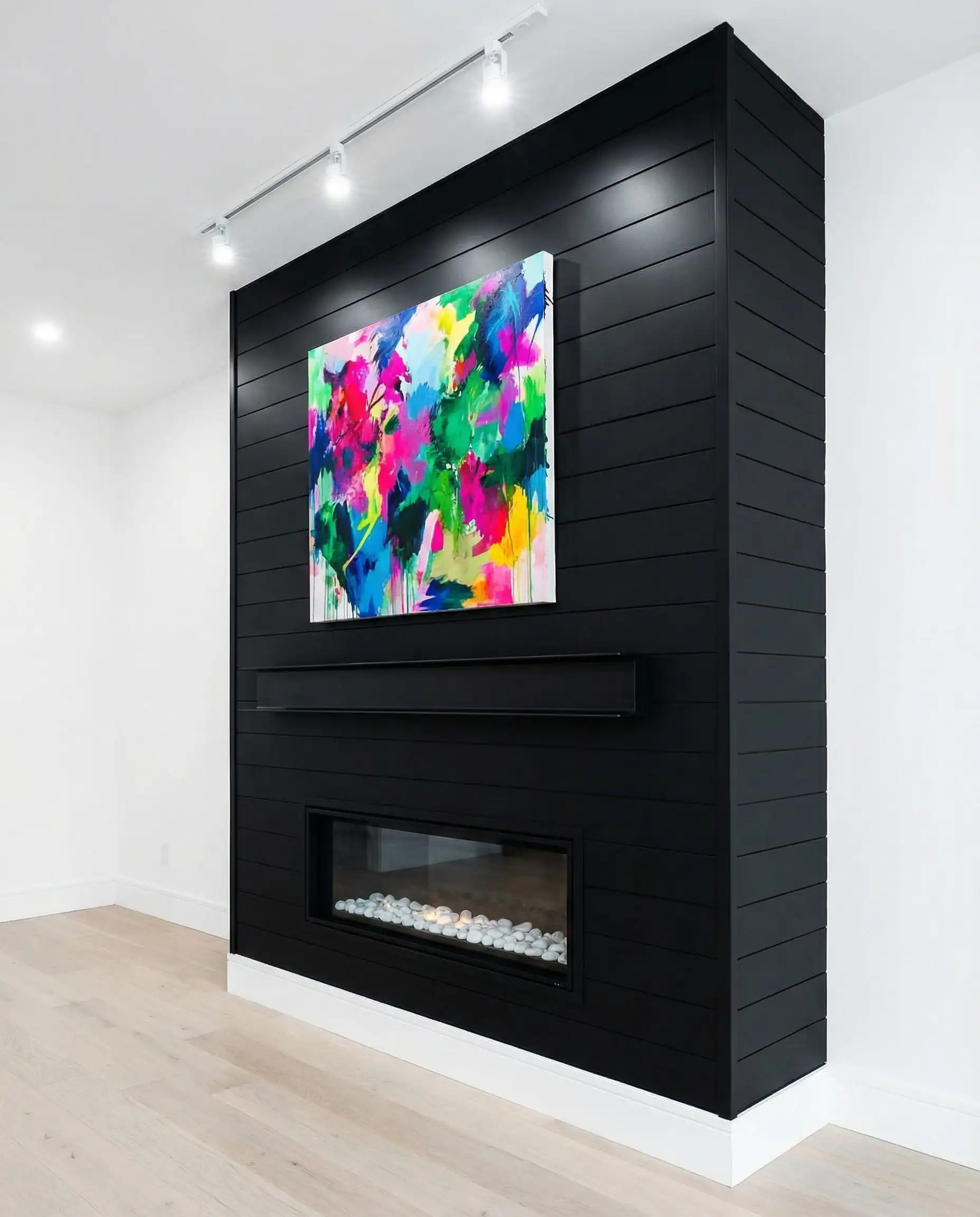 High contrast fireplace wall painted in Sherwin Williams Tricorn Black against white walls.