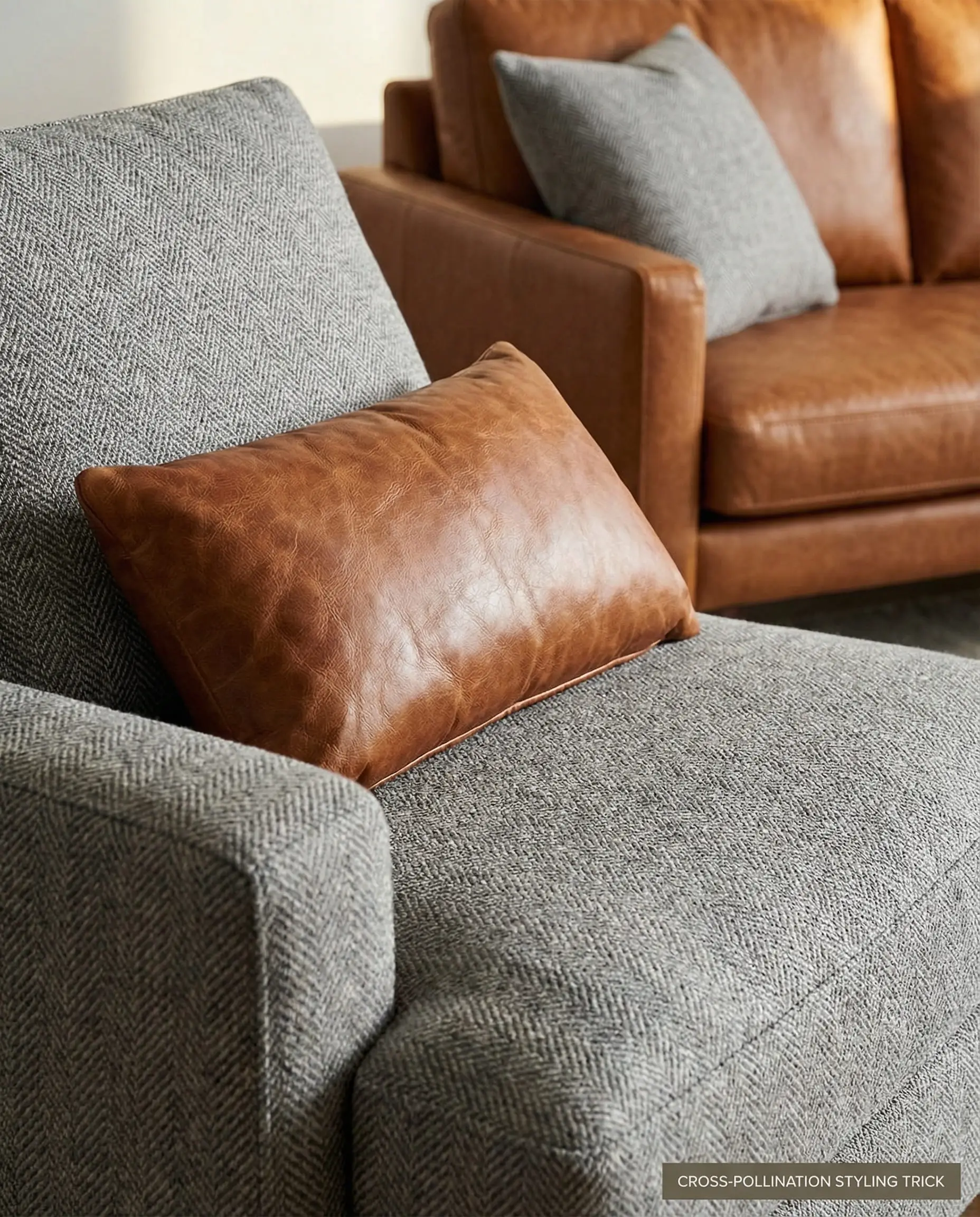 Close-up showing a leather pillow on a fabric sofa, and a fabric pillow on a leather sofa in the background.