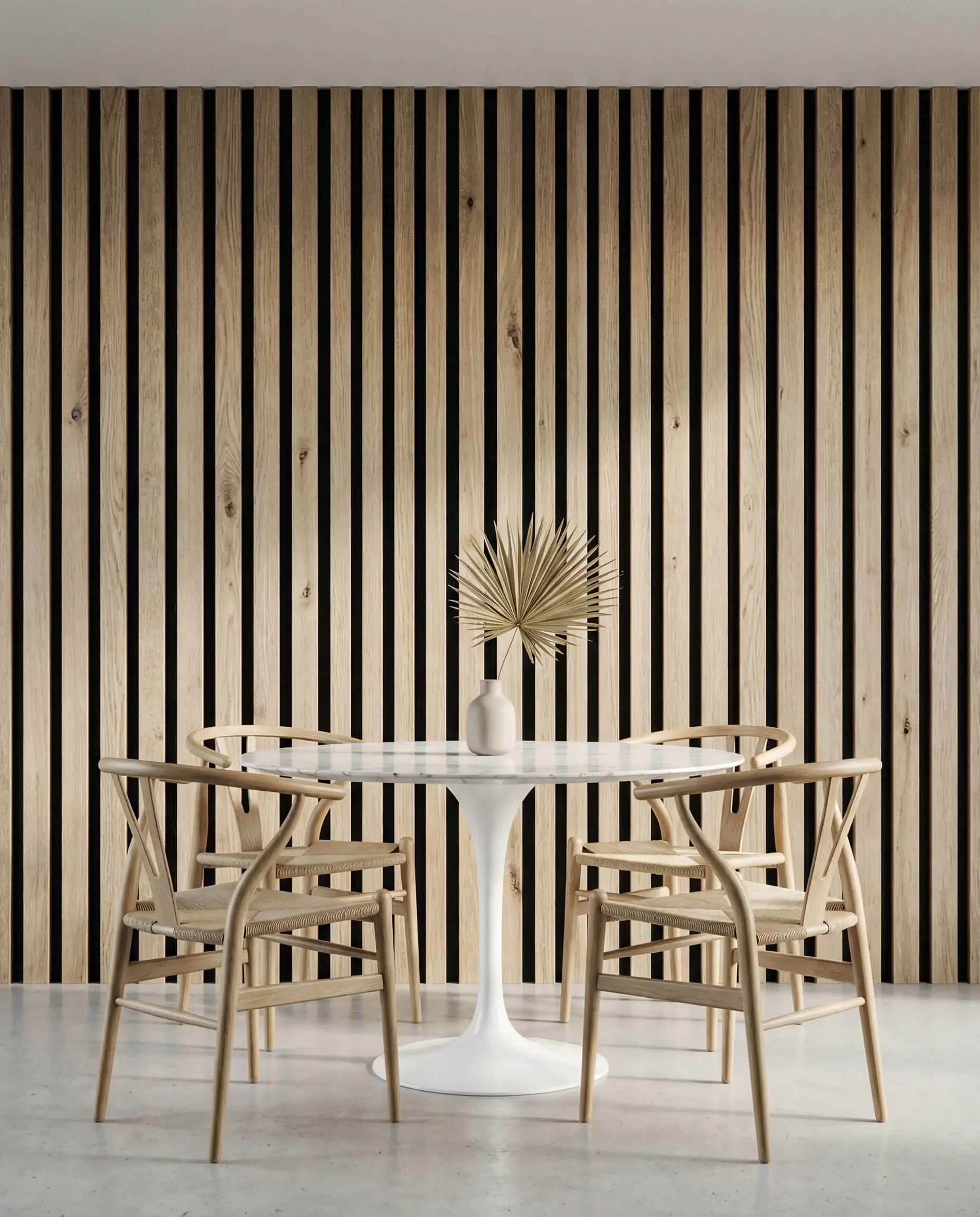 Scandi-modern dining room with floor-to-ceiling vertical white oak slats backed by black acoustic felt, paired with a round tulip table.