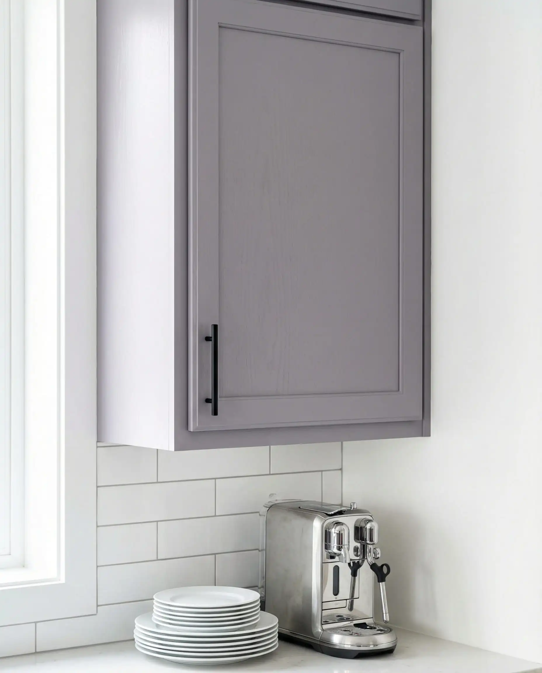 Educational shot showing a violet-gray cabinet door against a clean white wall to demonstrate purple undertones in daylight.