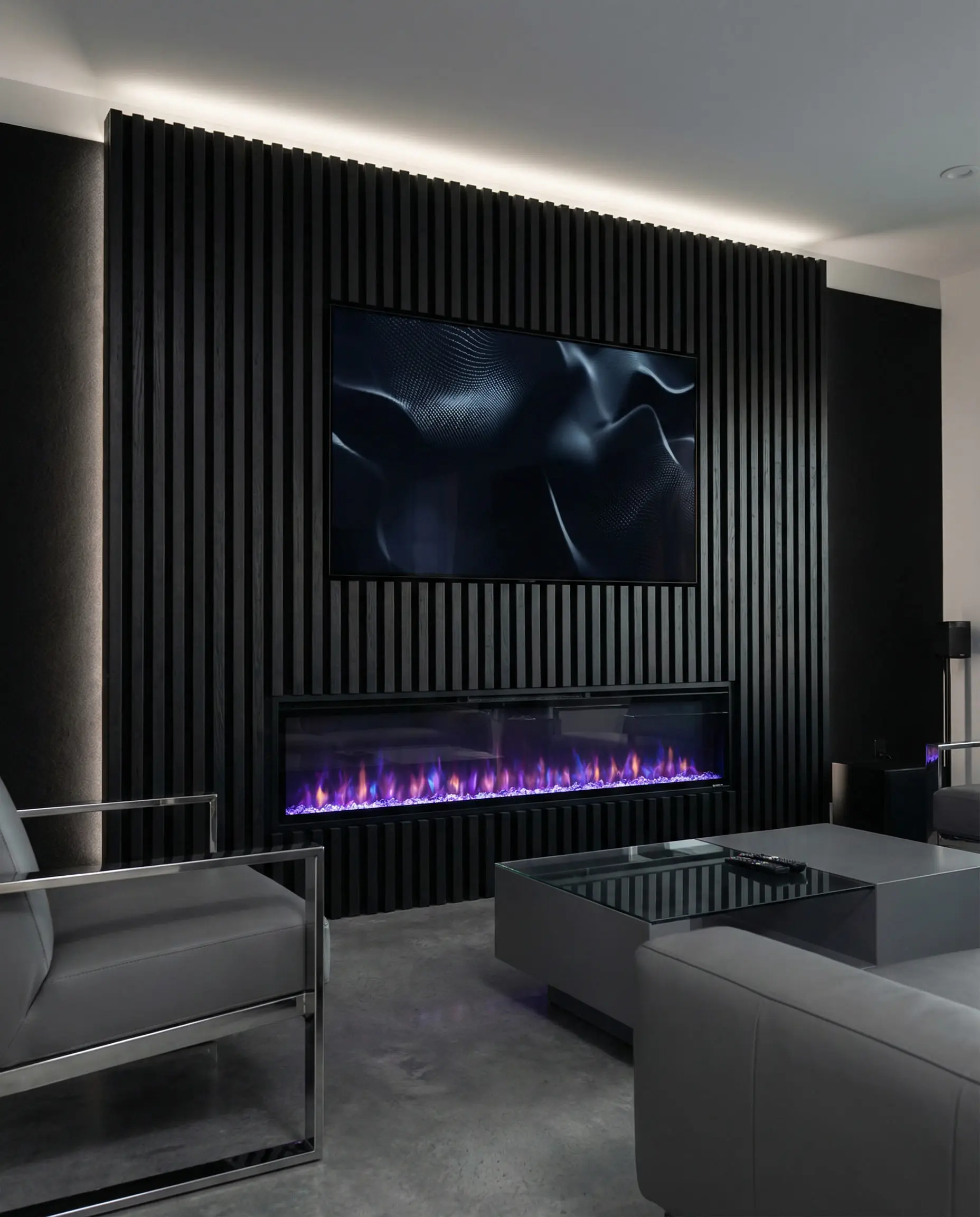 A stealth-look media wall featuring black wood slats that camouflage a flush-mounted TV above a linear fireplace.