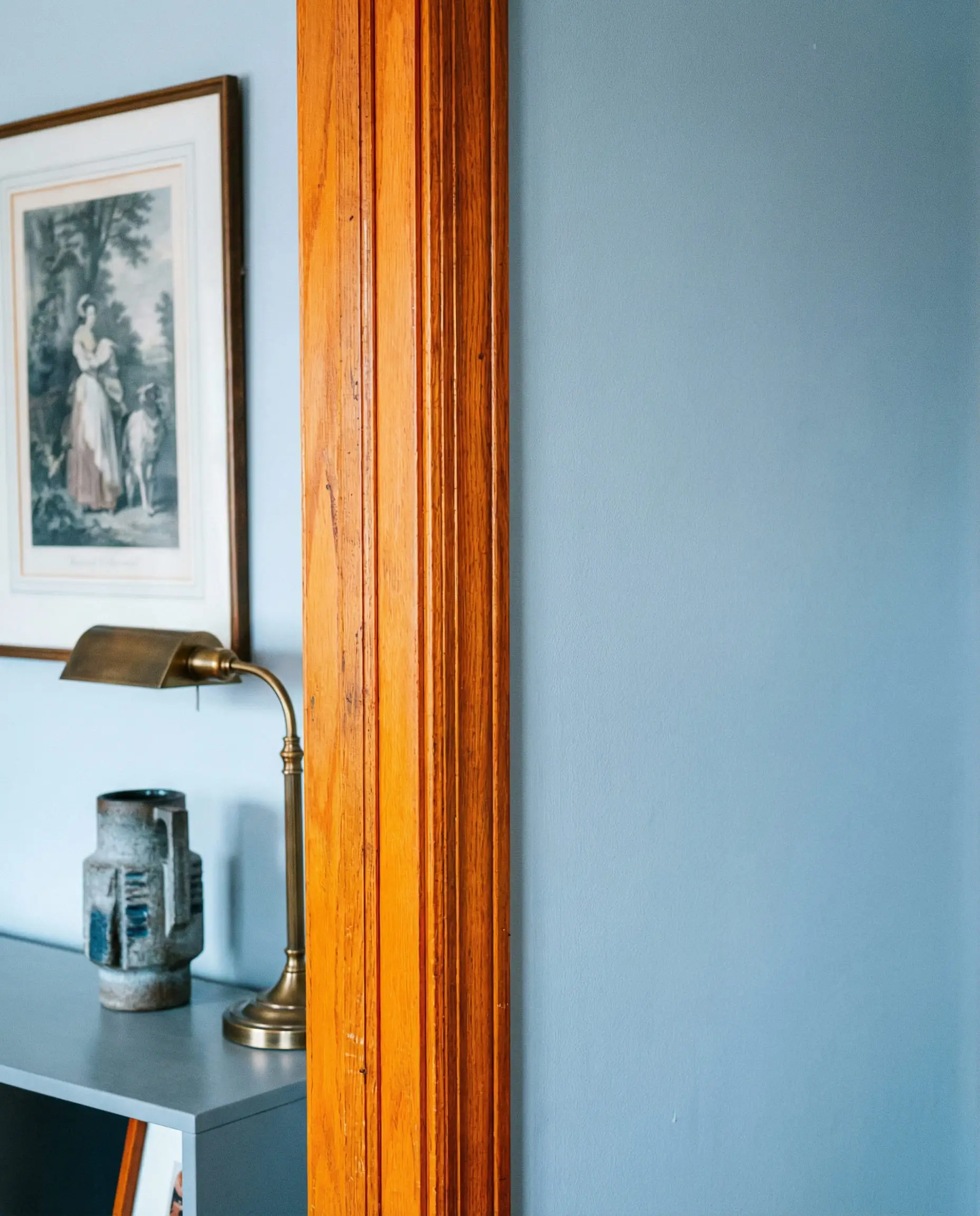 Example of interior design mistake showing cool blue-white paint clashing with honey oak trim.