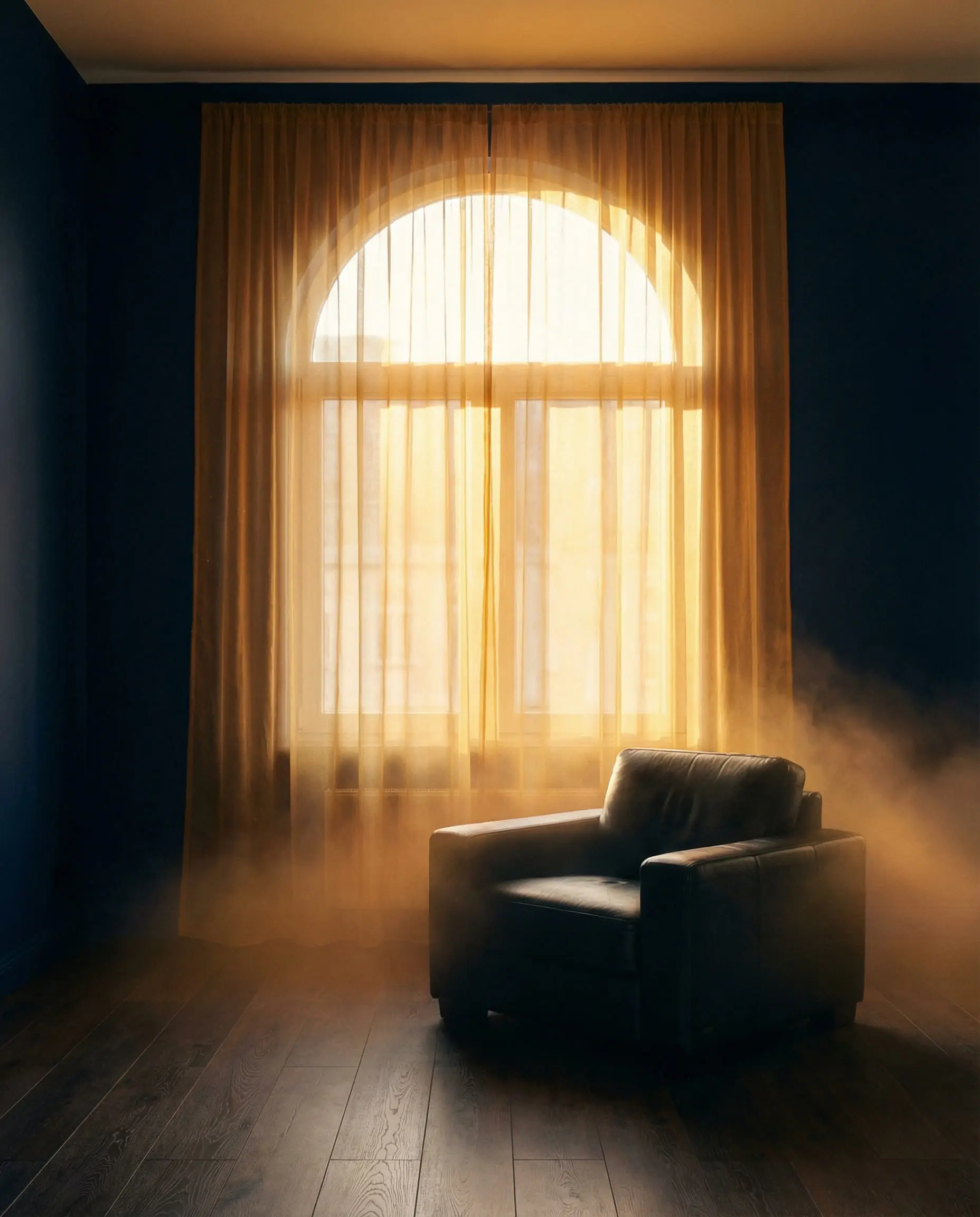 Minimalist midnight blue room with sheer golden organza curtains glowing in sunlight.